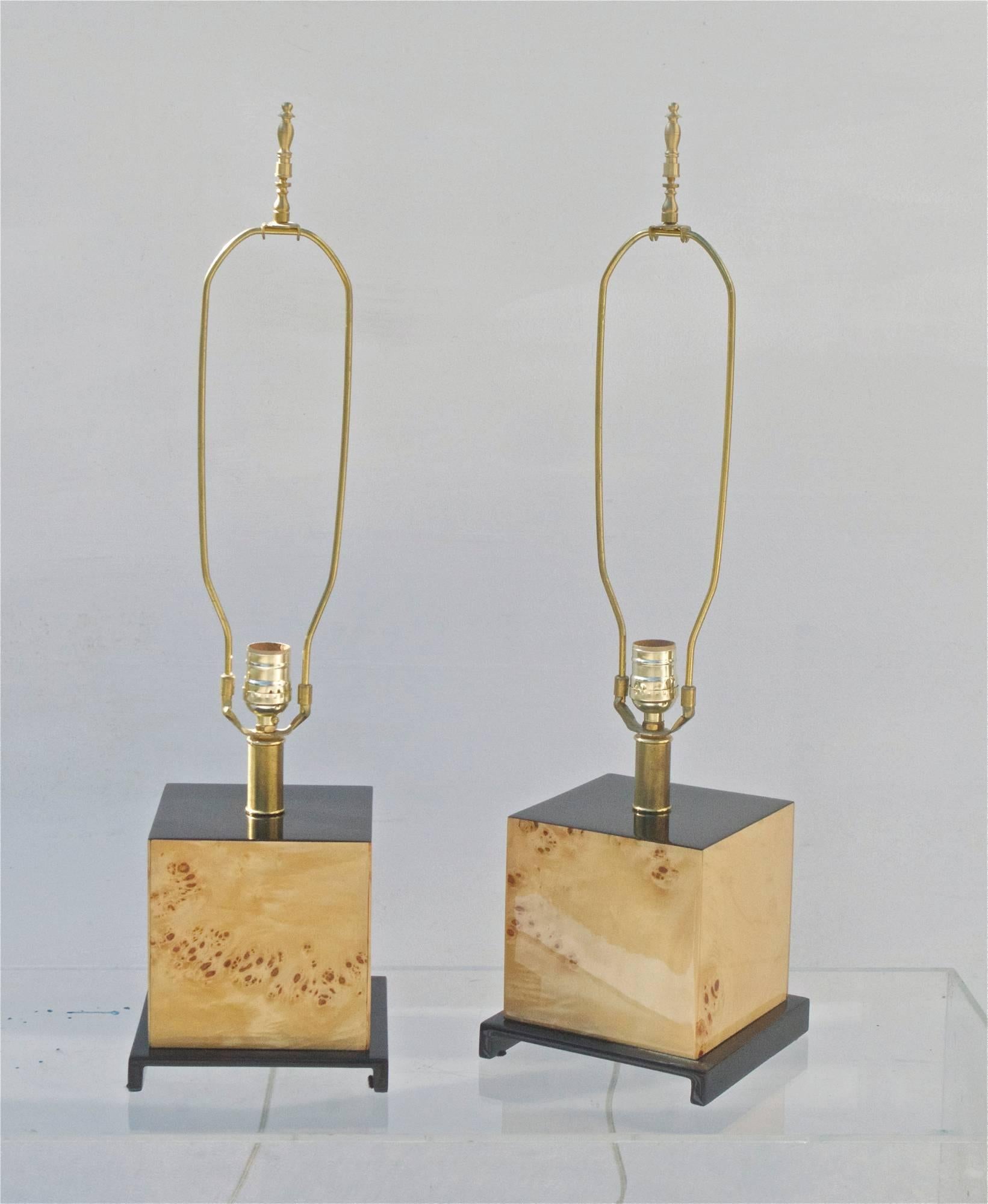 A spectacular pair of 1980s boudior lamps of maple burl wood resting on simple Asian inspired risers. Original tall silk blended shades are included, and are in excellent condition. Lamps work well.