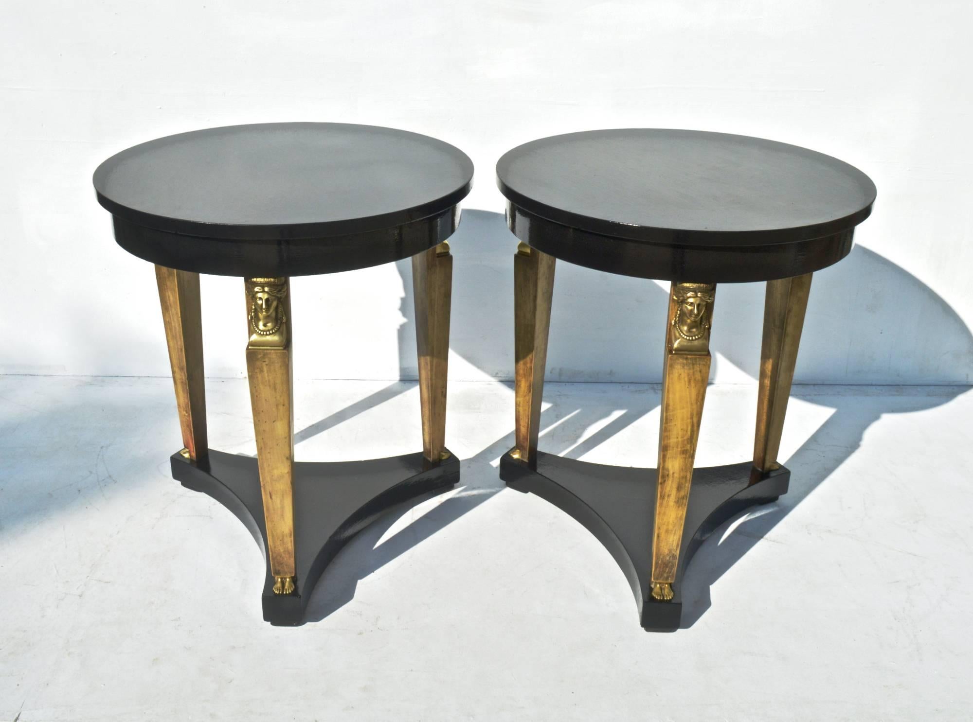 Pair of striking Neoclassical Revival end tables by Baker Furniture, circa 1980, the tables shimmer in a recently applied black lacquer by Fine Paints of Europe. On each table, a gently tapering leg is beautifully accented by bronze 