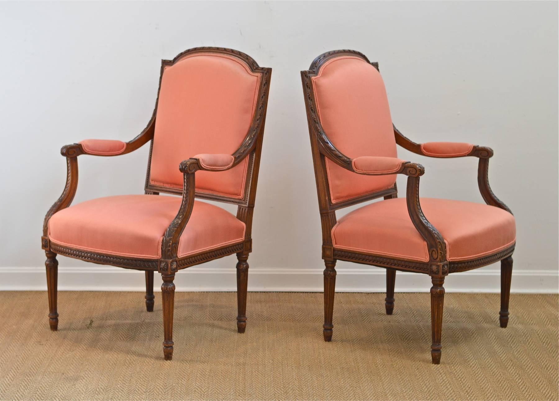 Fantastic pair of Louis XVI style fauteuils in fruitwood and coral fabric. Classic style. Two pairs available.