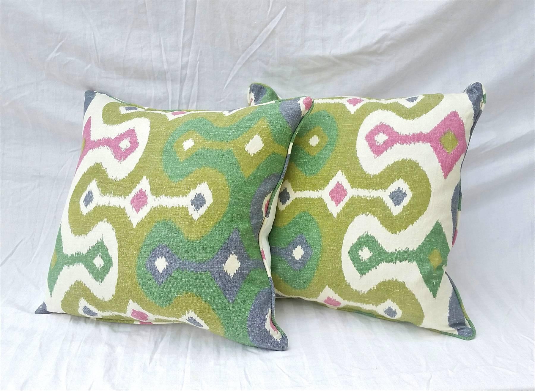 Pair of down throw pillows in Schumacher "Darya" Ikat linen fabric. Down inserts are 80% down/20% synthetic mix. Pillow covers are self corded and come equipped with hidden zippers.