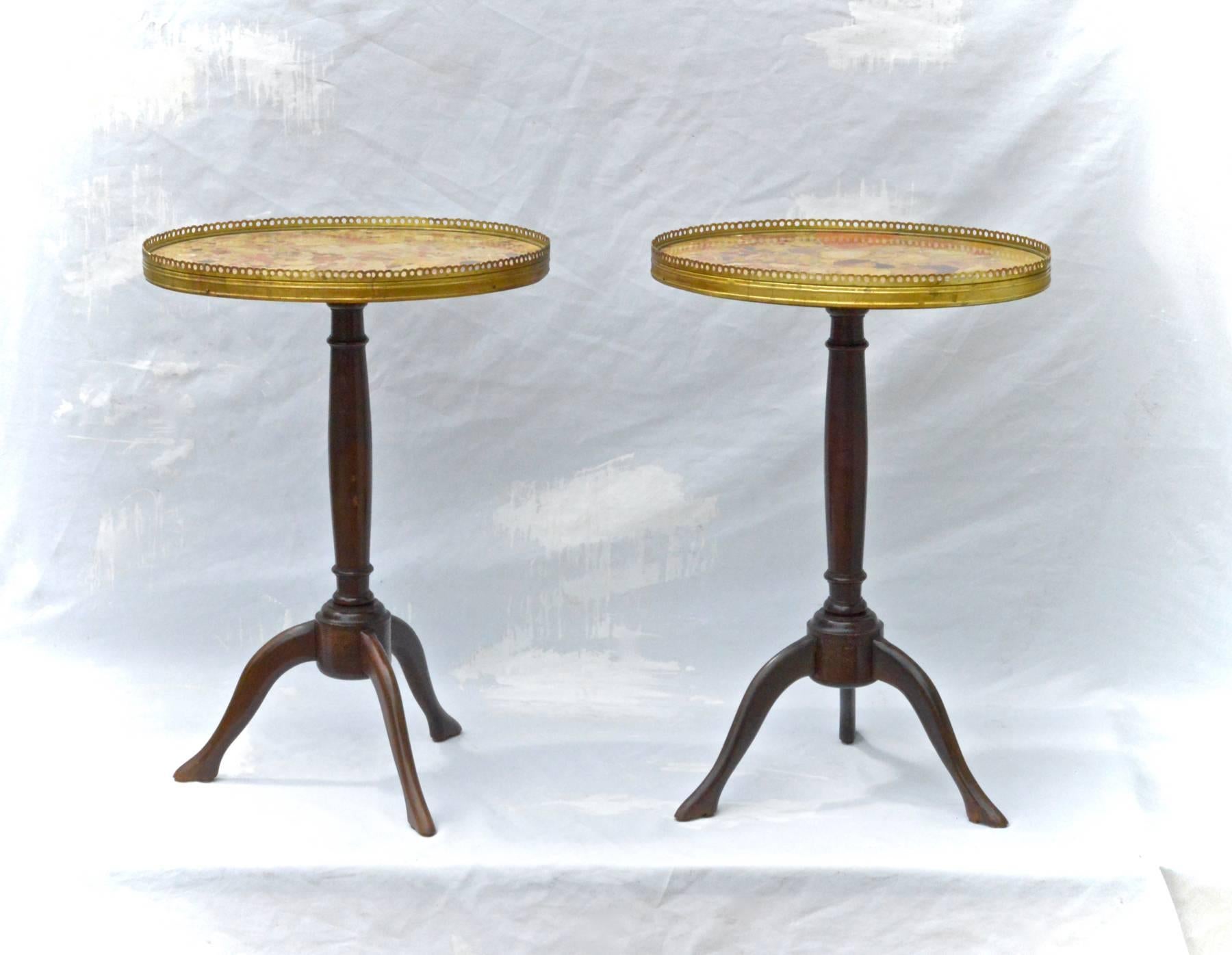 A pair of petite Louis XVI style French gueridon's having subtle boot form pad feet, mottled breiche marble tops housed in pierced gilt bronze galleries resting on turned mahogany column formed bases. Late 19th century. Old repair to pictured leg