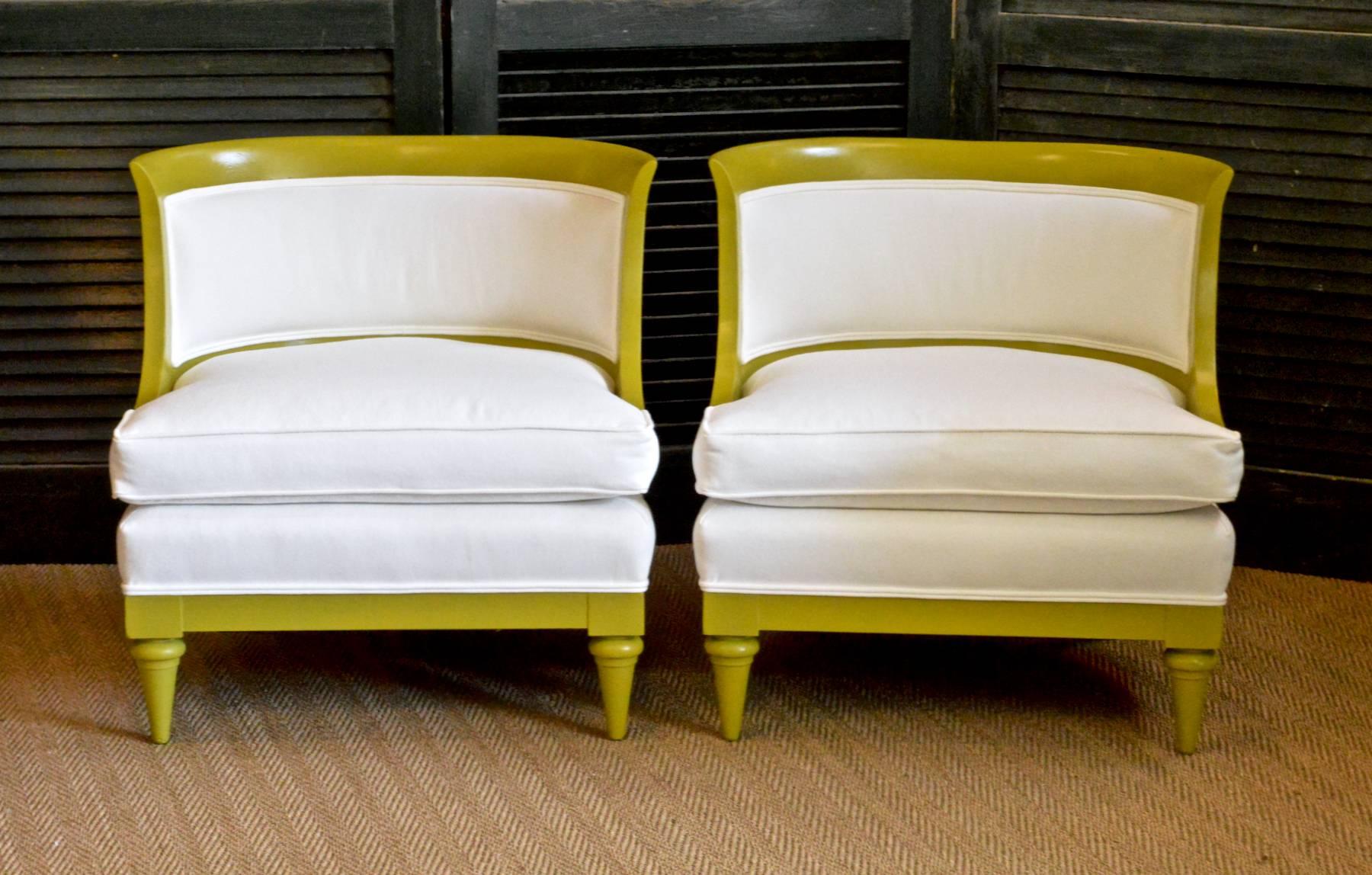 A pair of sexy slipper chairs having curvaceous barrel backs and sculpted down-swept arms. The glamorous pair of early 1960s low lounge chairs have been expertly restored from the ground up. Hand applied chartreuse enamel. Reupholstered in a soft