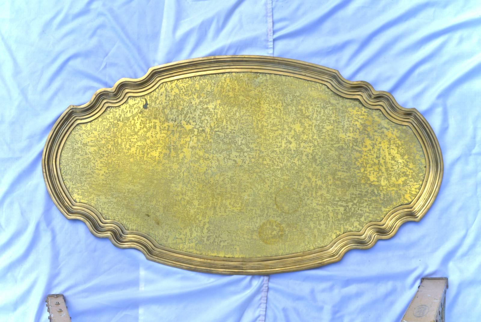 A large brass serving tray of epic scale. The cast and scalloped edged frame houses a single sheet of hammered and etched brass. A stunning serving or centrepiece.