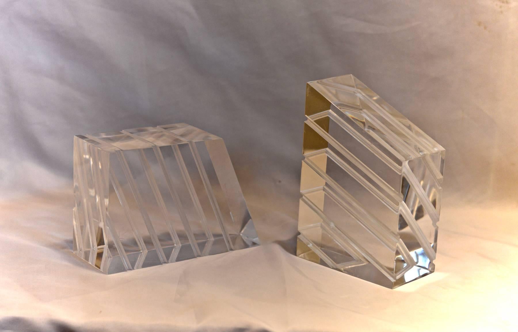 An eye-catching pair of Lucite bookends of trapezoidal shape.
