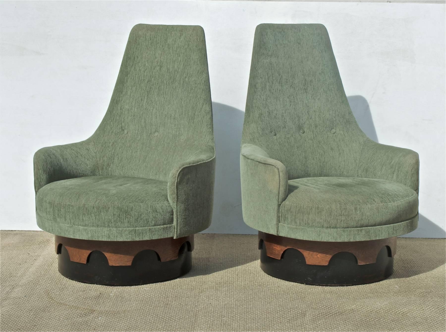 Iconic Mid-Century Modern swivel chairs by Adrian Pearsall. The pair of lounge chairs were made by Craft Associates and are of a particularly unique design, most notably the 360 degree swivel function. Chairs are sporting a medium green chenille