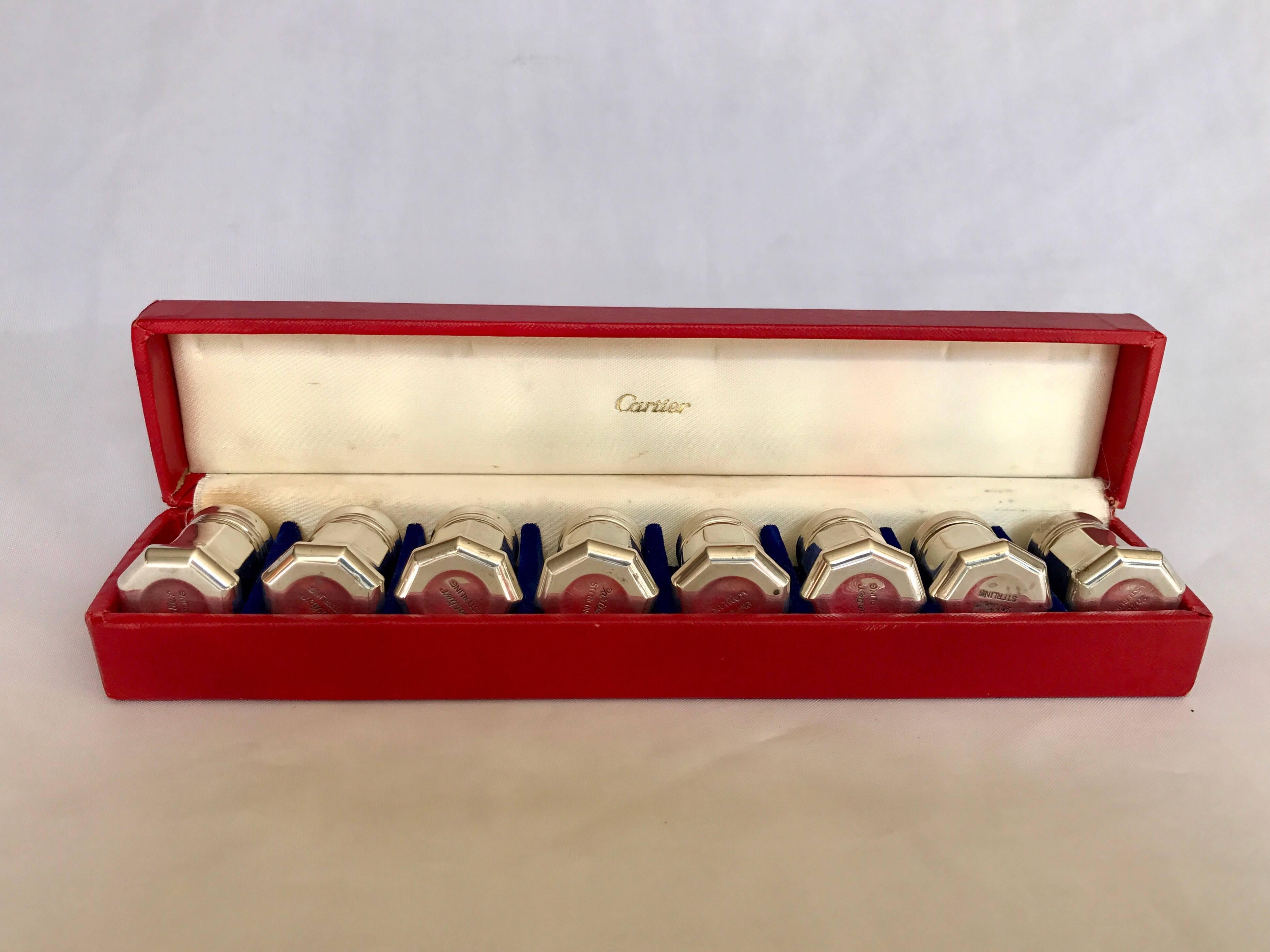 A set of eight sterling silver salts by Cartier in original red satin lined box, circa 1965-1970. All salts stamped underside. In very good to excellent condition and ready for your fine home.
 