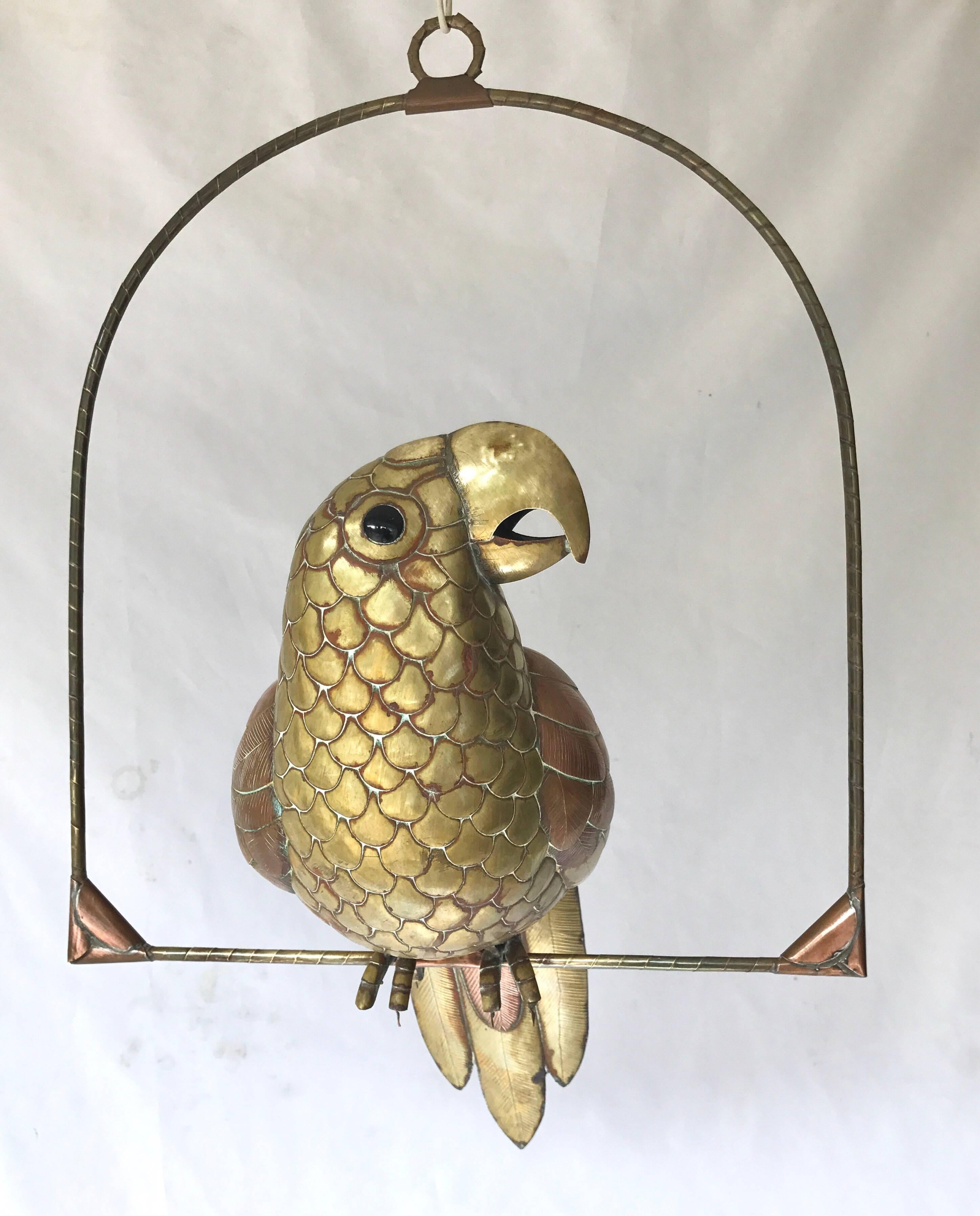 An eye-catching brass and copper parrot on perch attributed to Sergio Bustamante. High quality, hand hammered parts and construction teamed with black glass eyes, give this bird presence and wonderful scale.
Body measures 10