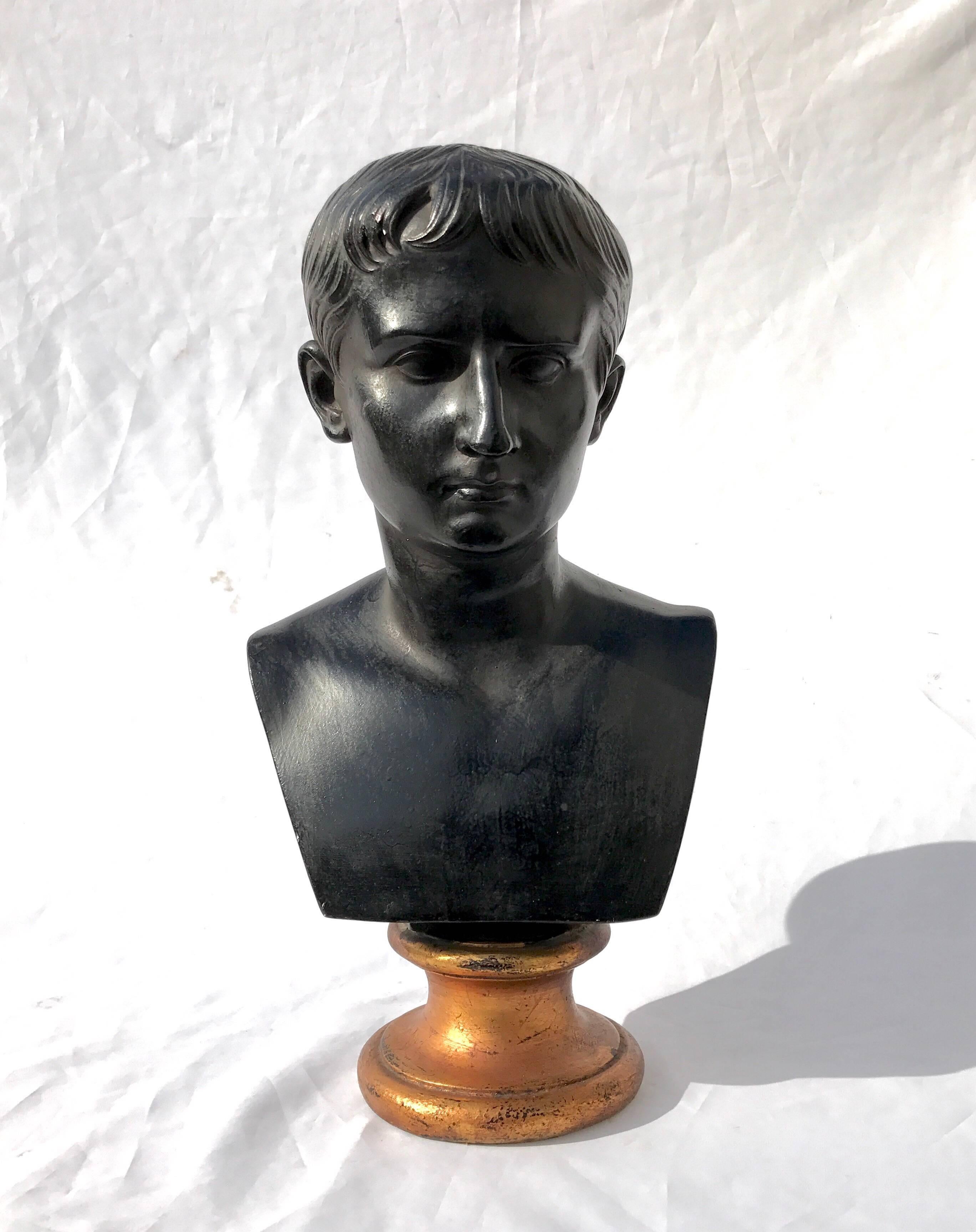 A fetching black plaster figural bust in the Classical taste. The vintage cast and decorative piece has style to spare. 