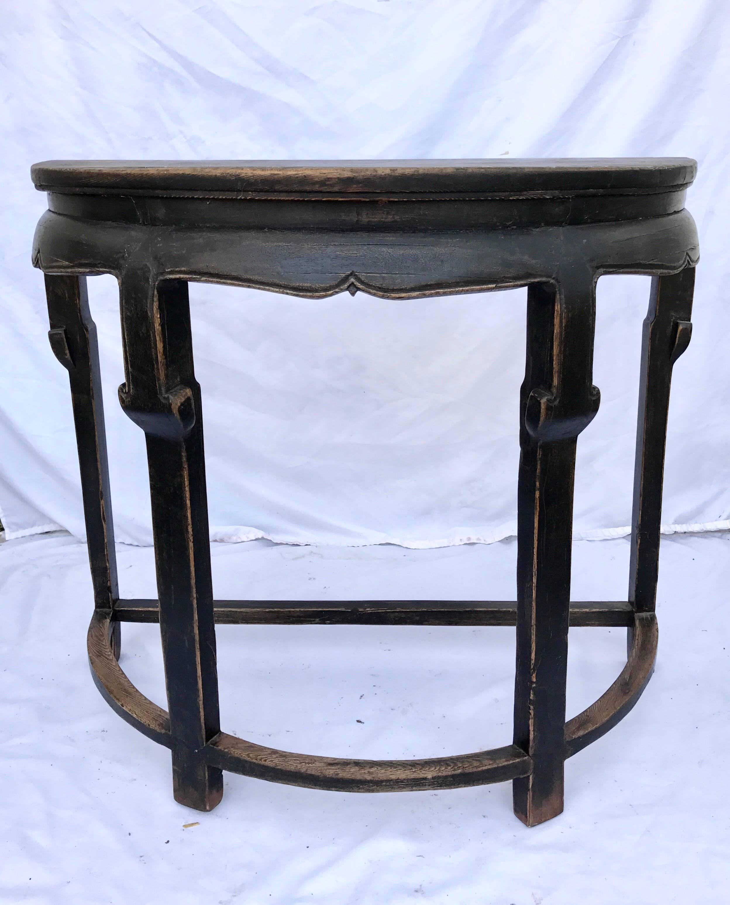 A good looking Chinese export console table of demilune form. Composed of stained and ebonized pine and elm, the half round table is as versatile as any table out there. Simple rustic elegance and classic refined lines here. 