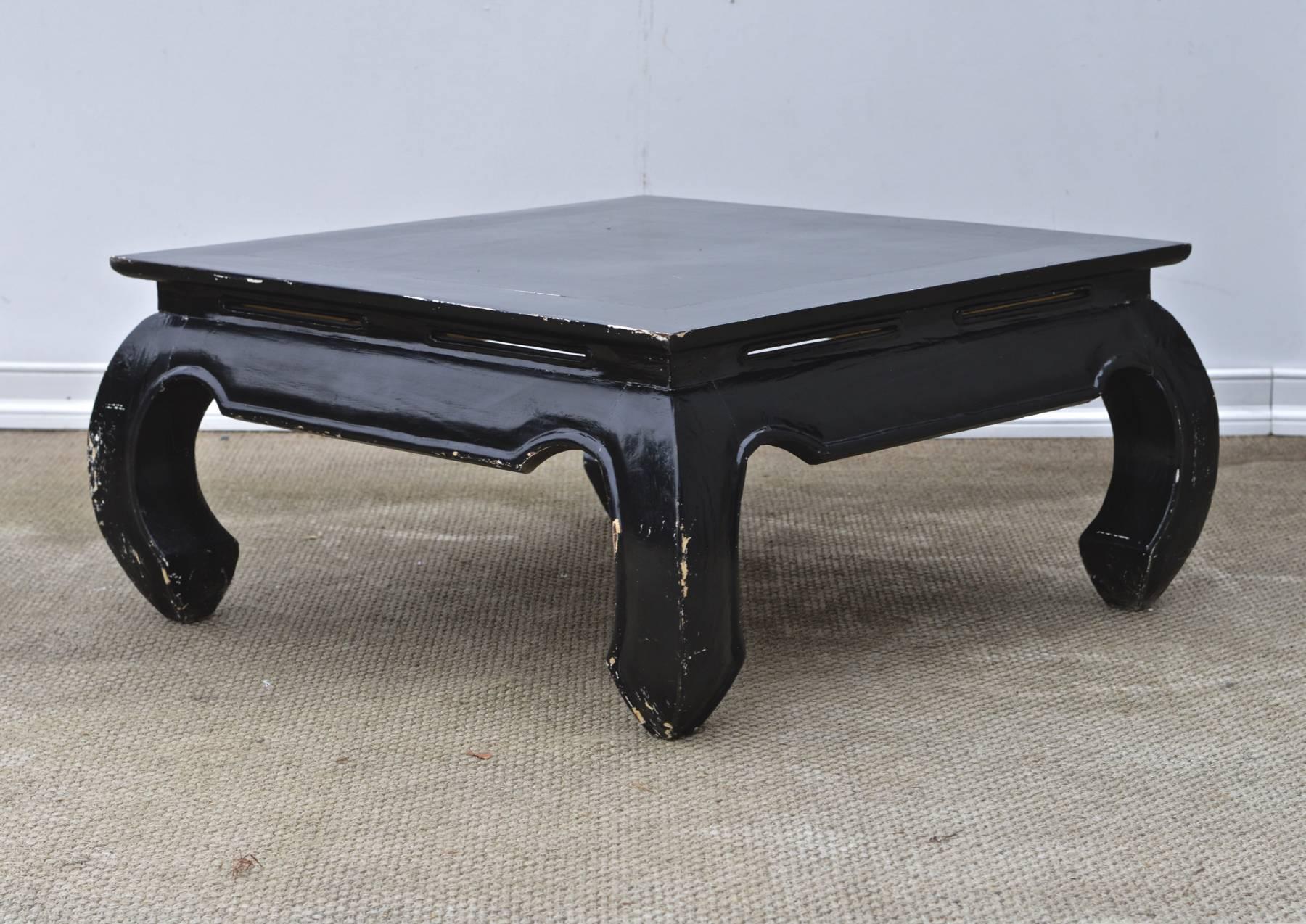A vintage ming style coffee table having a rustic ebonized finish. 
