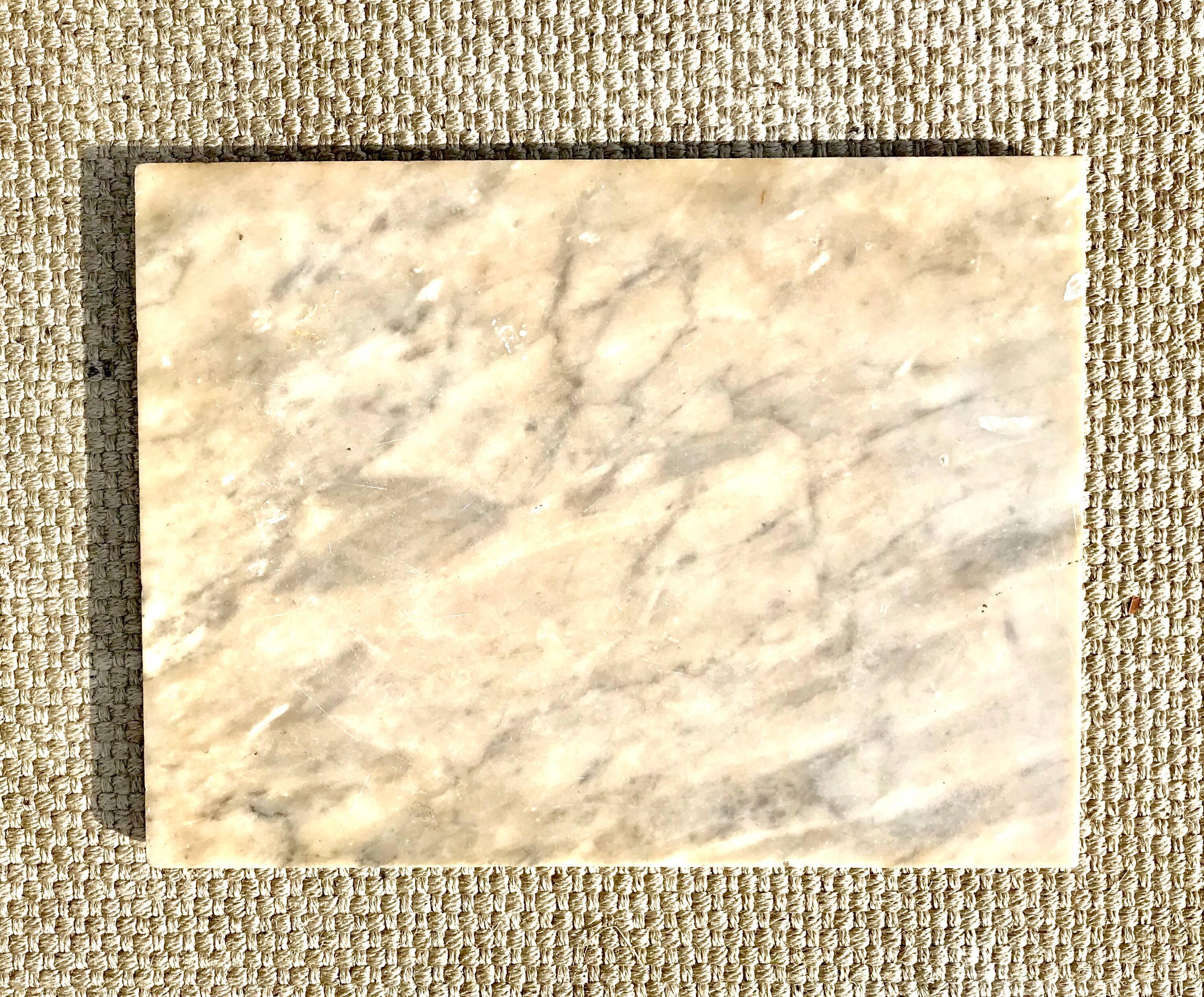 A rectangular lazy Susan of antique Carrara marble. The patinated and smooth stone adds warmth when used on a kitchen island as a condiment and or spice depot.