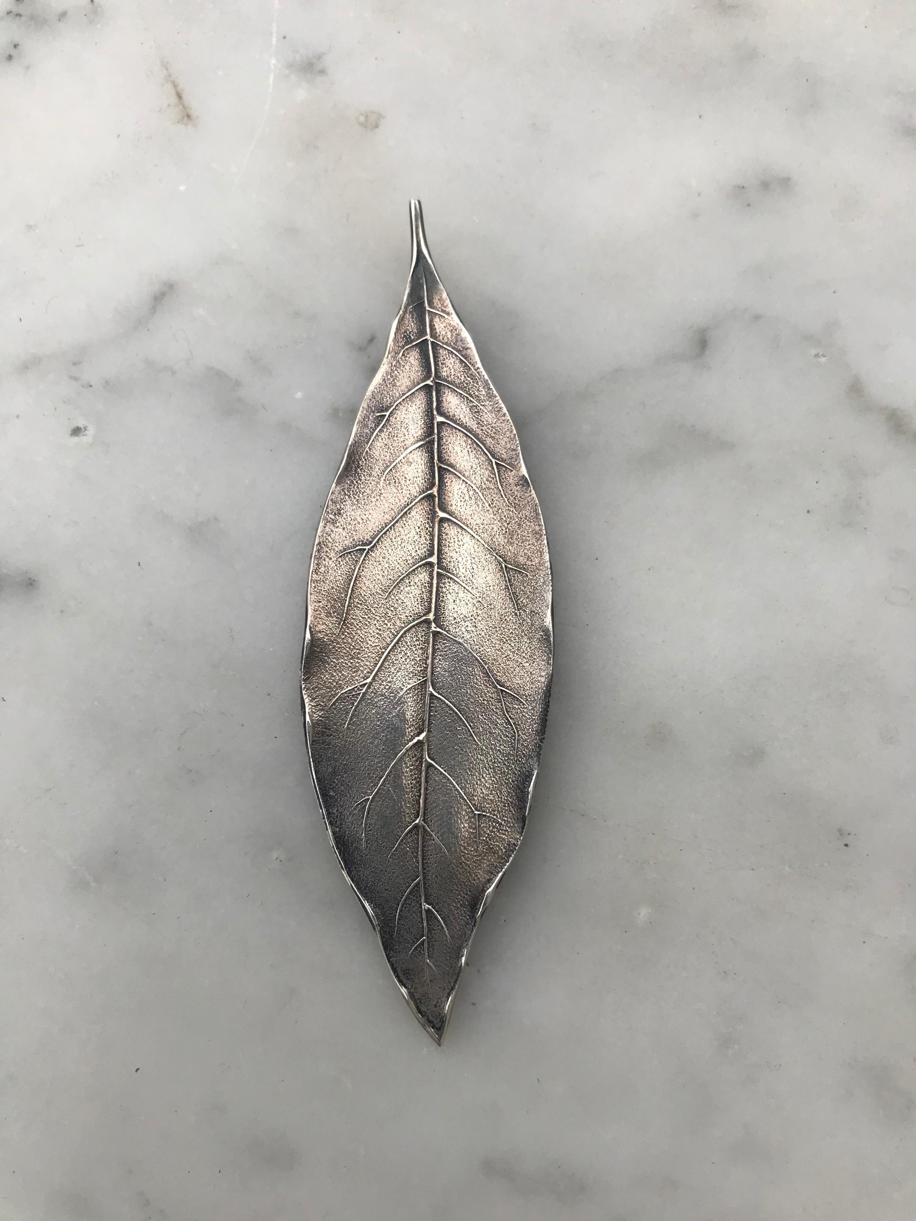 A brilliant sterling silver cast leaf form bookmark made by Tiffany and Co. Classic and timeless style.