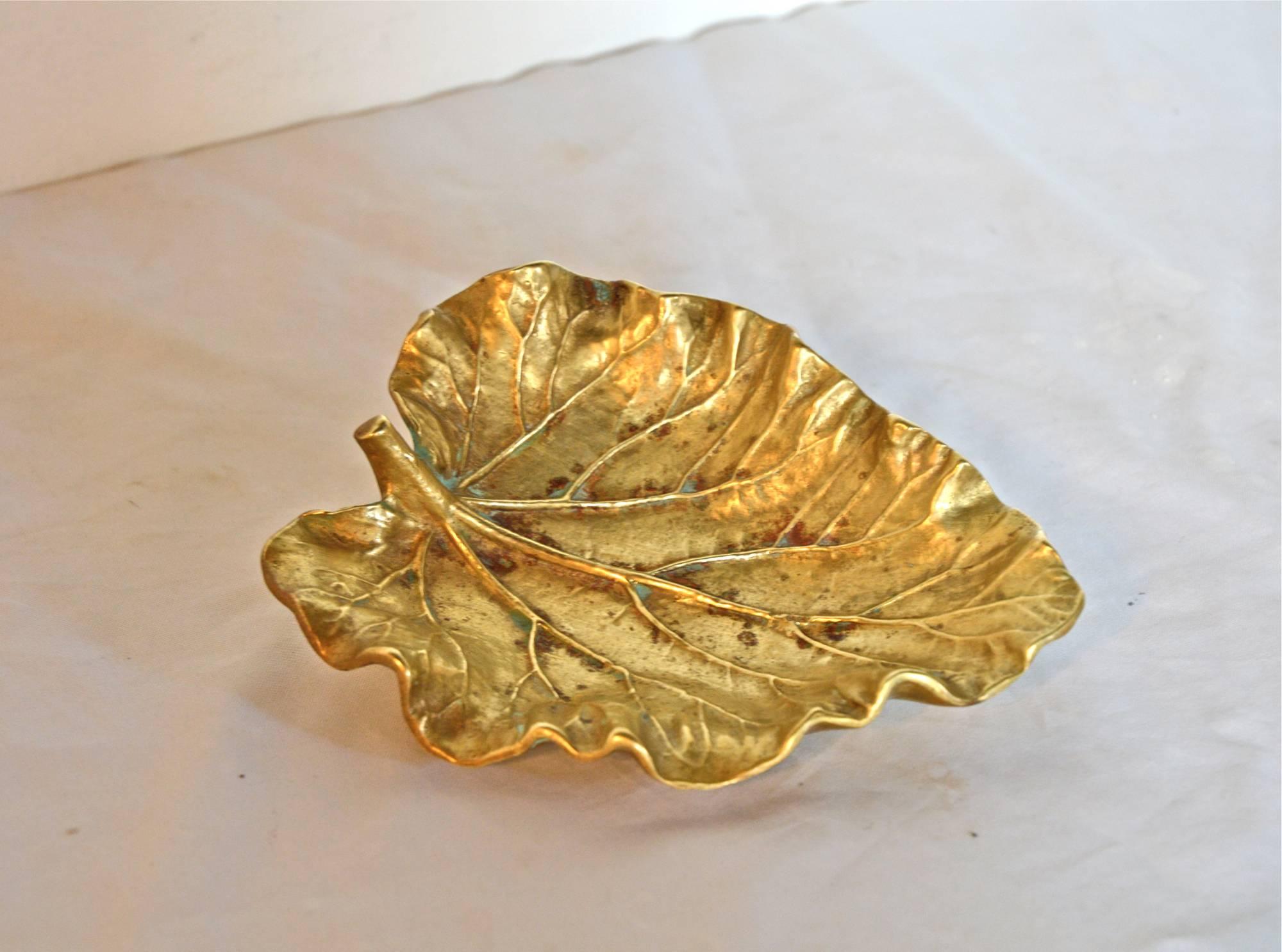 A stunning and highly detailed brass casting of a rhubarb leaf which makes a highly versatile candy dish, catch all or jewelry keep. Stamped Virginia Metalcrafters, copyright 1948.