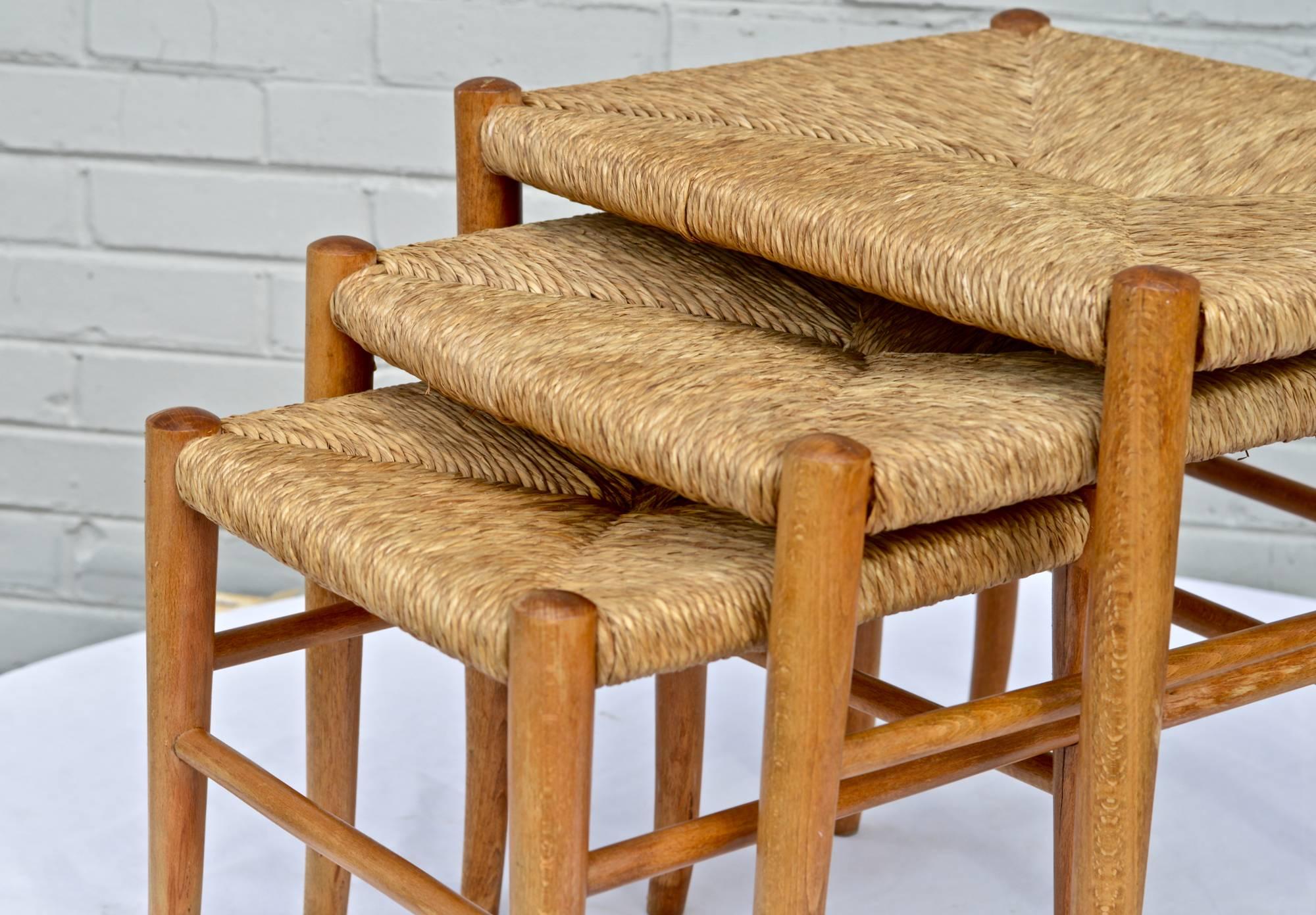 Set of three nesting stools of ash and rush cord in the manner of Gio Ponti. The smartly designed stools or stands are stamped 