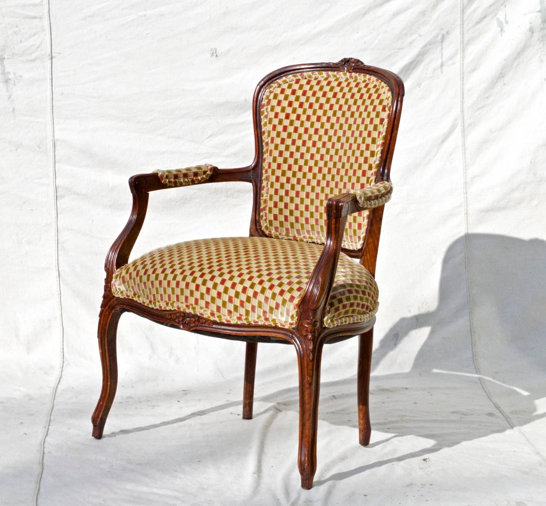 A vintage 1960s Louis XV style fauteuil having open and down swept arms and elegant cabriole legs. The single chair is dressed in a very high quality cut velvet in an interesting foulard pattern. The back panel is adorned in a pink and green striped