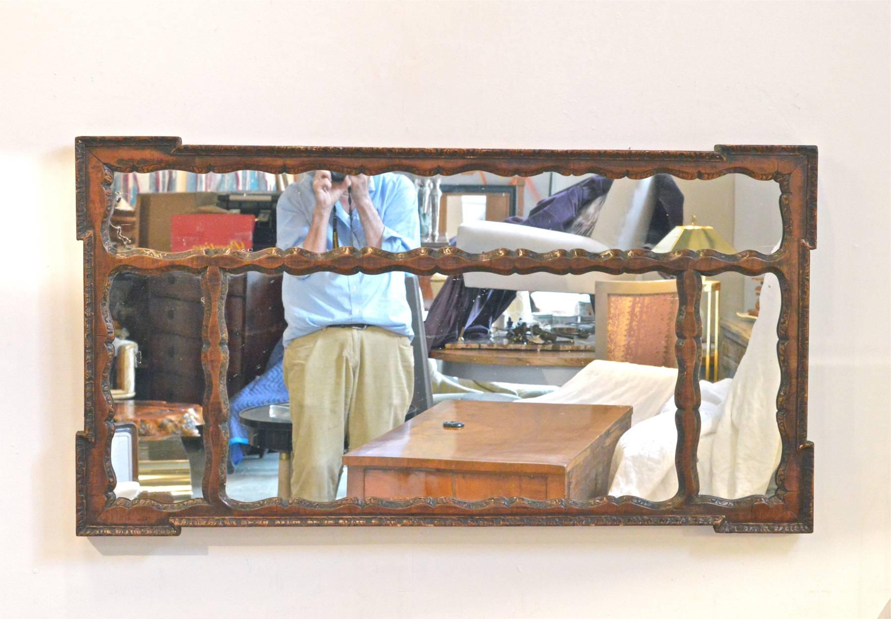 Unusual mantel mirror in the Spanish Colonial taste. The mahogany frame can be hung horizontally or vertically to your taste. Mirror has that certain rustic 