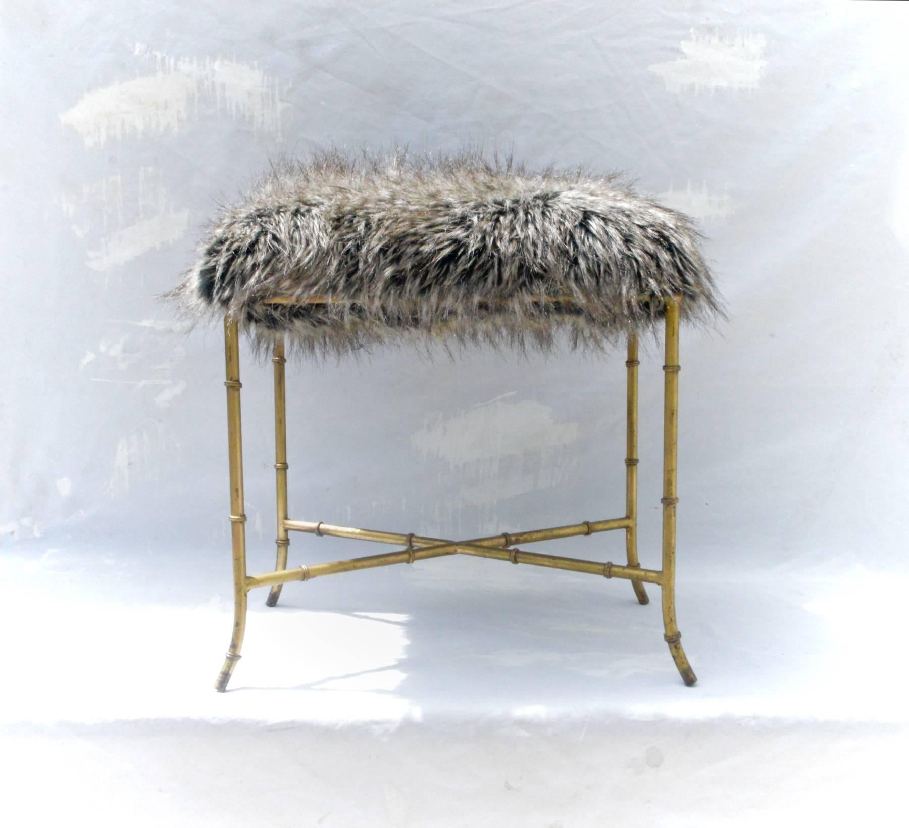 Italian gilt iron bench of faux bamboo form having a plush and comfortable seat of arctic fox flokati. The circa 1960 petite bench can easily be employed in a multitude of spots in any contemporary interior. Strong, sound and sturdy.