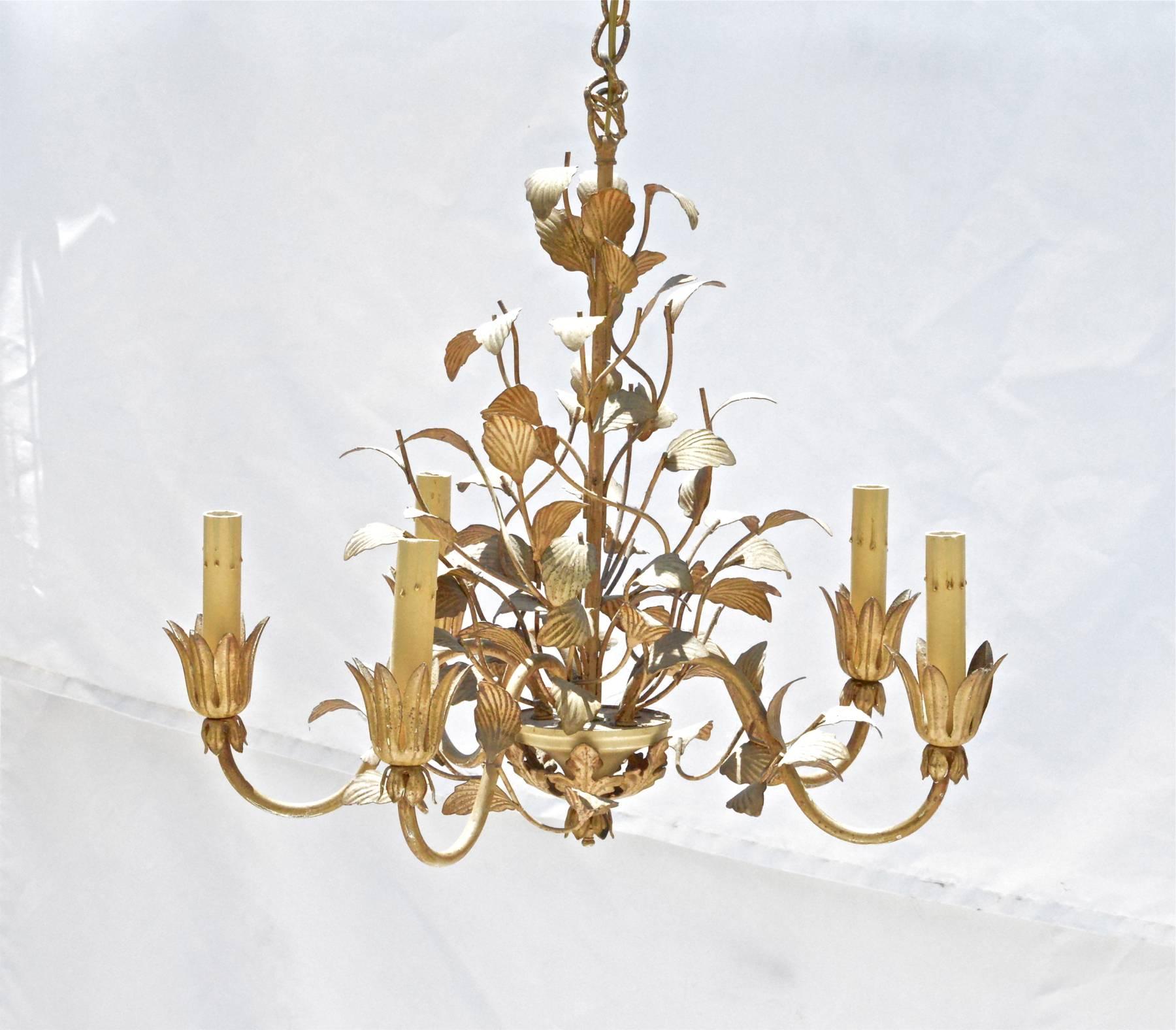 A petite tole' painted chandelier having five arms and five lights. Dark cream and umber tones. Size is perfect for a rustic powder-room. In good working condition. Additional photography and video of chandelier working available upon request.