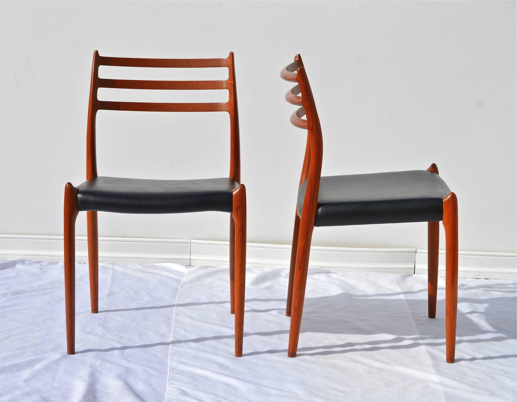 A fine pair of model 78 dining chairs by N.O. Moller. The gorgeous and sculptural Danish modern chairs are in excellent structural condition throughout and possess a richness of woodgrain that set them apart from other teak wood models of this