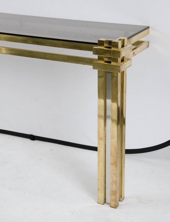 A pair of 1970s console tables signed Romeo Rega in gold-plated finish and original brown glass tops.