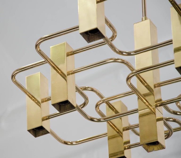A 1970s Gaetano Sciolari nine lights chandelier in a gold finish.