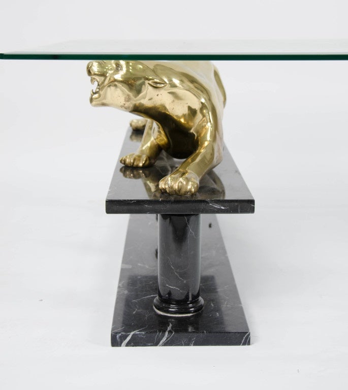A very unusual and rare 1970s coffee table. Black marble base with light veins, solid brass panther sculptures.