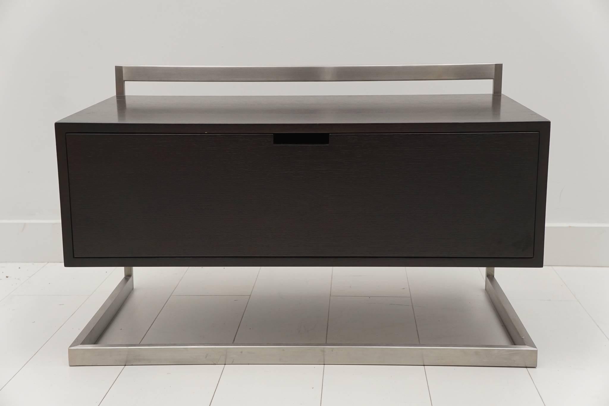 Custom Niedermaier wenge end table with one drawer and satin stainless steel frame.