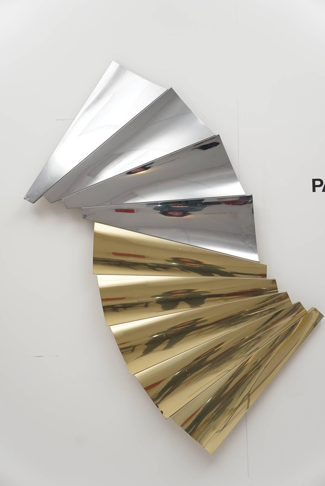 Wall-mounted sculpture of brass and polished chrome, signed C. Jere, 1985.