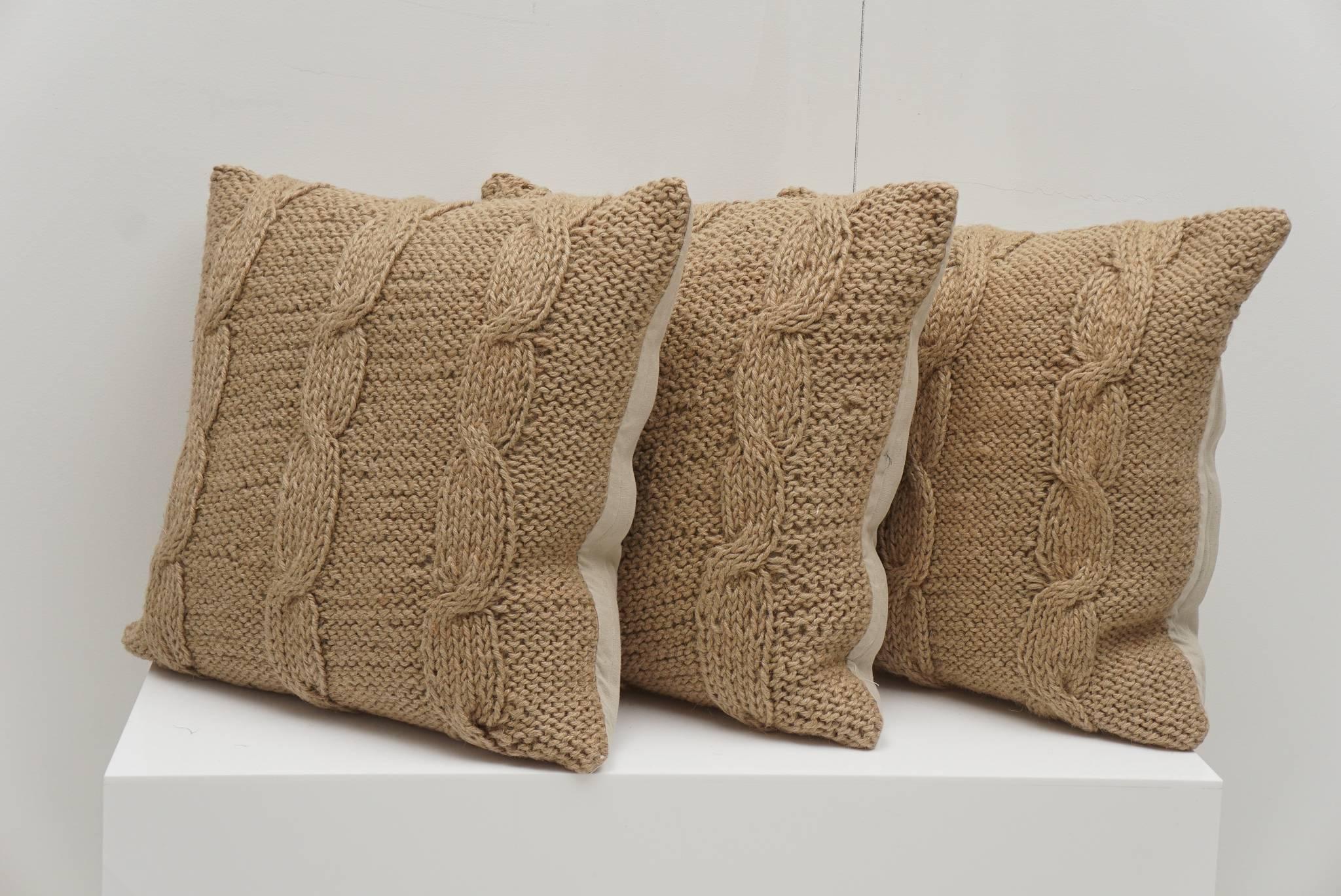 Brown hemp fabric cable knit design provides a timeless beauty to these pillows. Cotton backs with 50/50 down fill. Set of three pillows $275.00