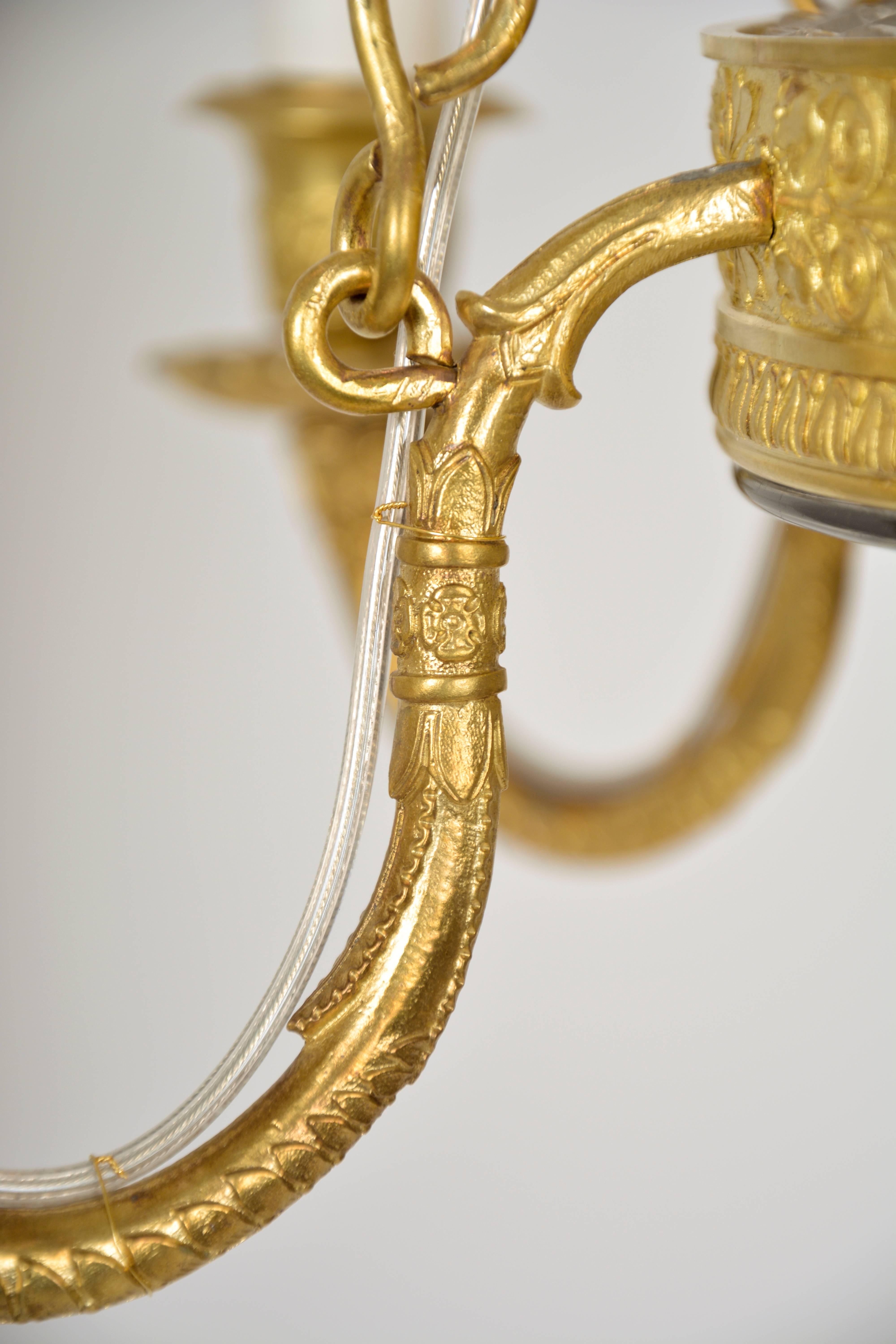 Brass Empire Chandelier with cut glass and gilded cast brass frame For Sale