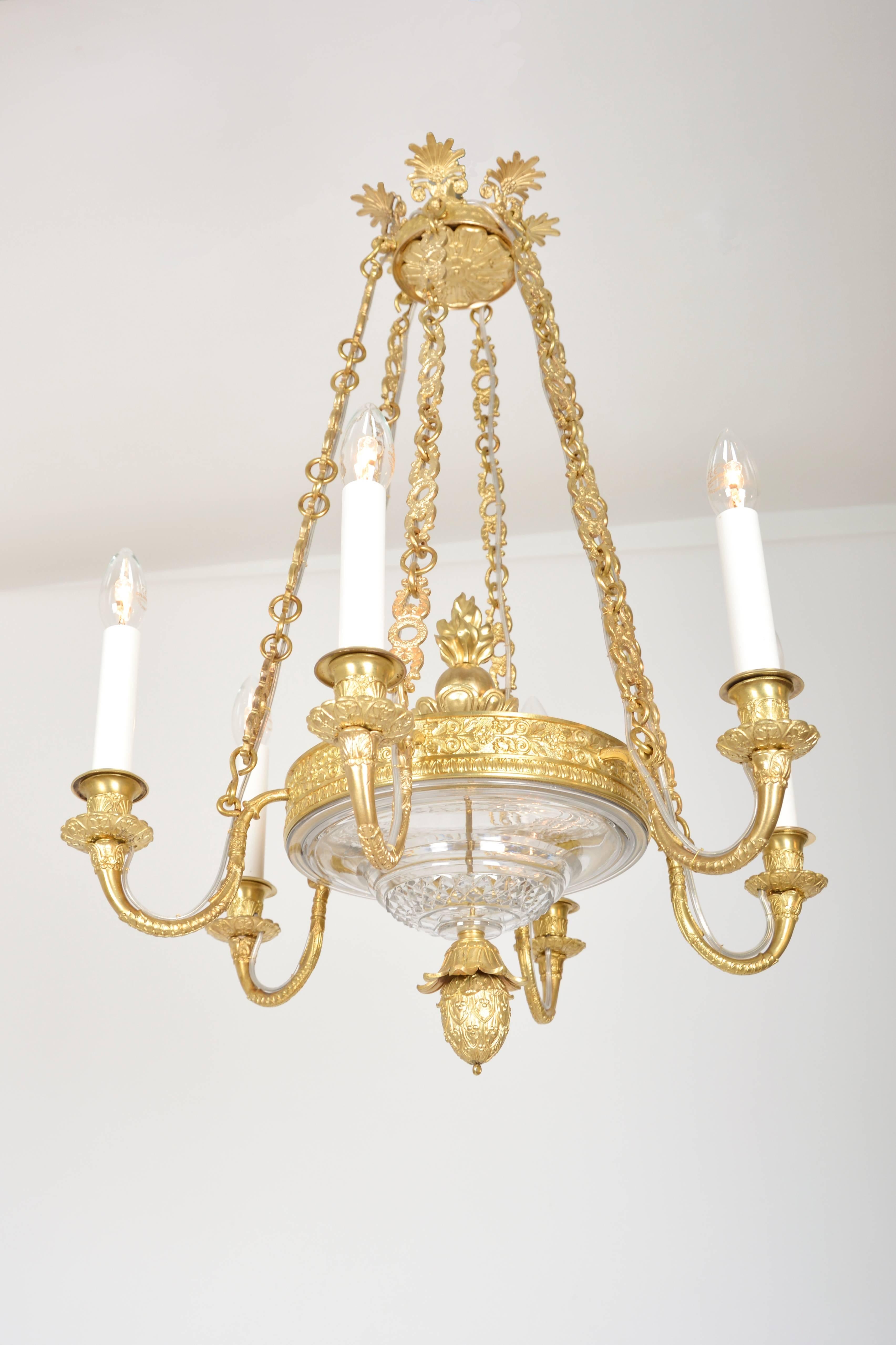 Cast Empire Chandelier with cut glass and gilded cast brass frame For Sale