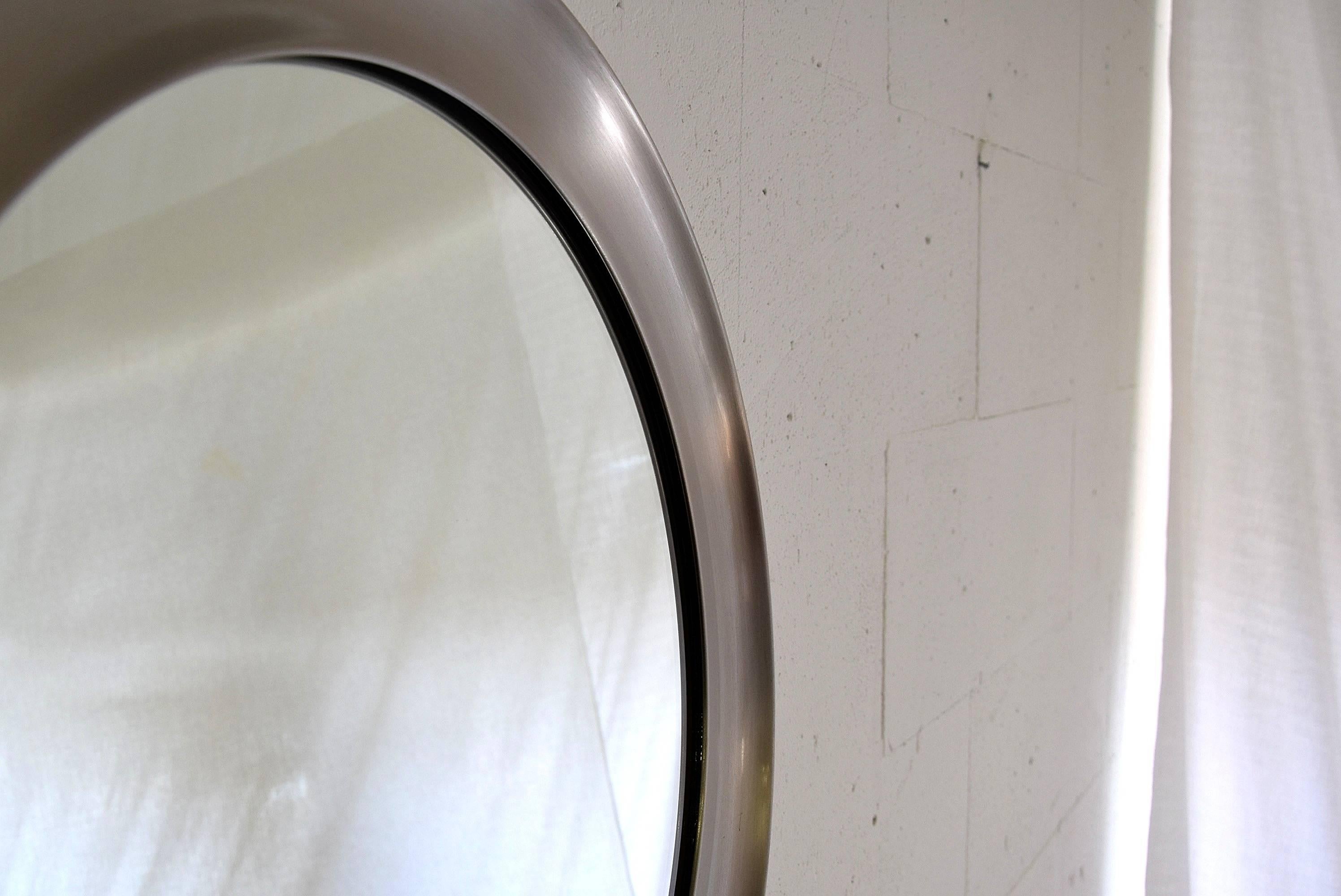 Very nice mirror designed in 1957 by Sergio Mazza for Artemide. The mirror is made of brushed stainless steel and is in great condition.
Measurements: D 62 x D 4 cm.
Sergio Mazza is an Italian designer who was born in 1931 in Milan. 

In 1955 he