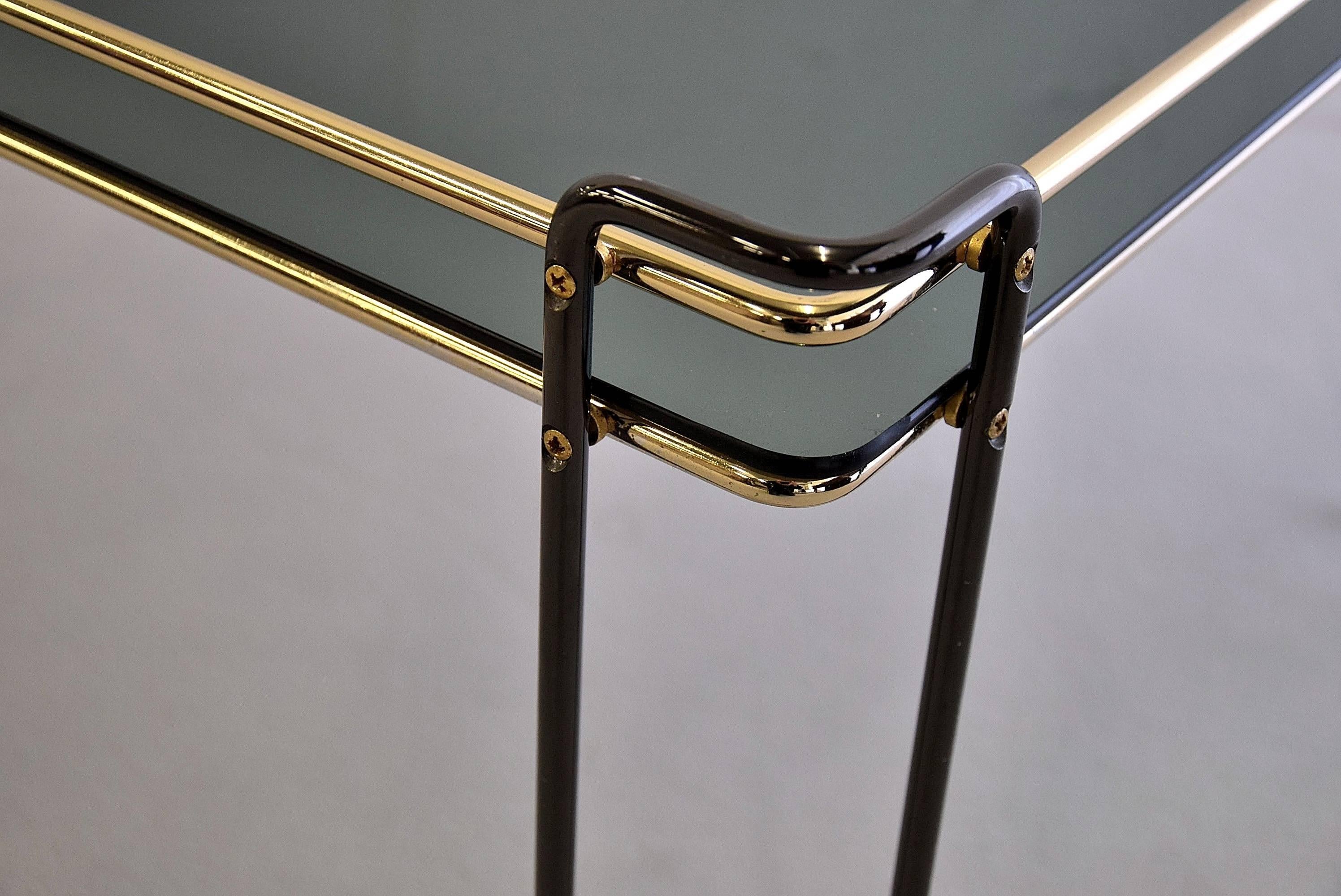 Elegant 1970s greenish smoke glass Italian side table with black and gold details.