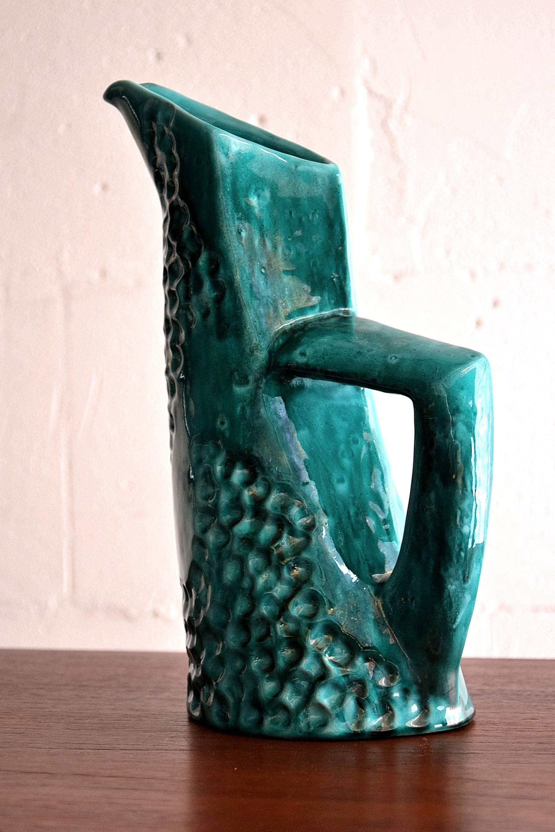 Futuristic shaped ceramic carafe in beautiful shades of sea green.

Produced by Pucci ceramics in a small town called Umbertide in the province of Perugia.

The whole set is in excellent condition.