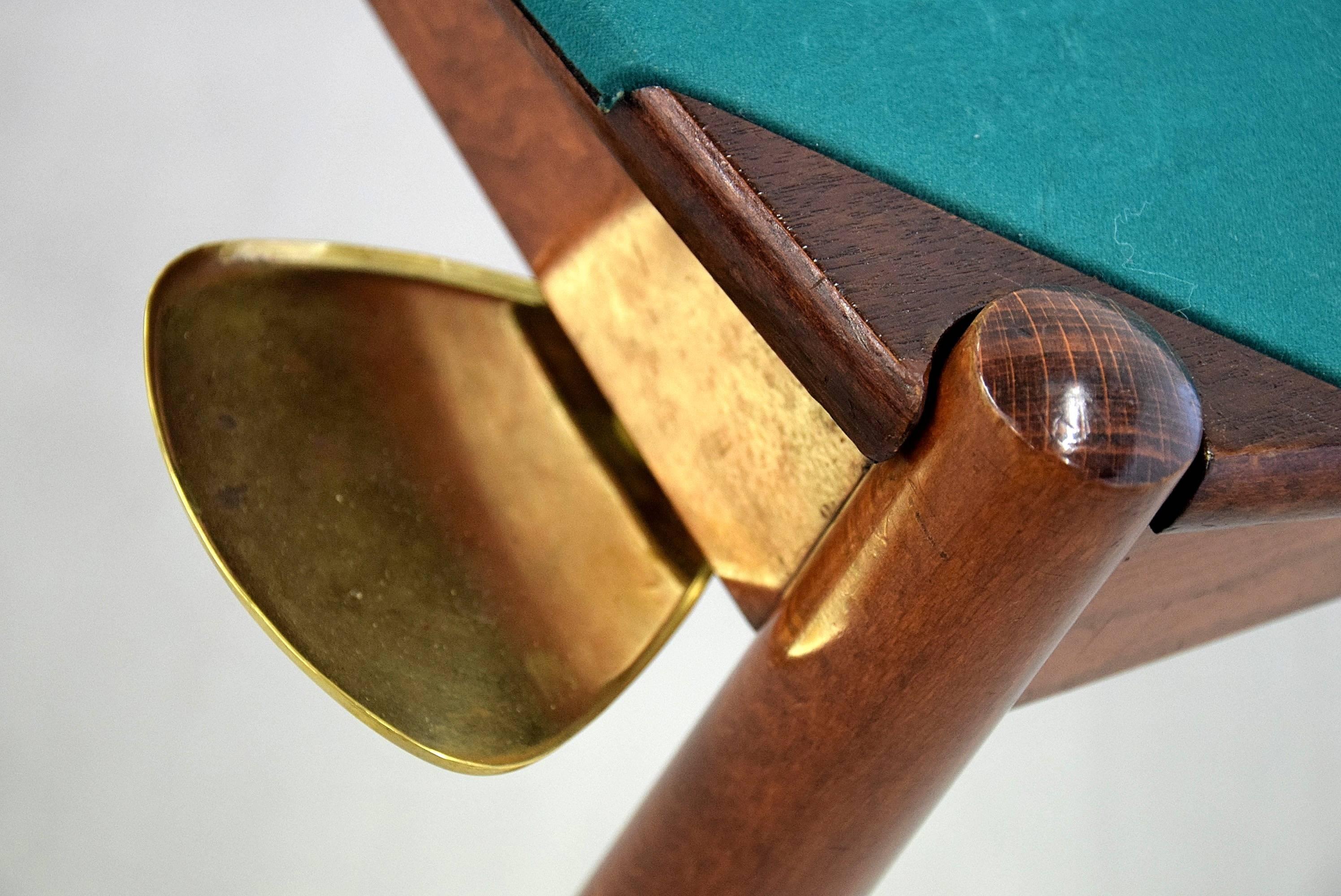 The most famous poker table in the world, designed by Gio Ponti and produced by the Fratelli Reguitti in the 1960s.

The top can be reversed to either the green felt or wooden top. Playing cards can be stored underneath.

On each corner brass