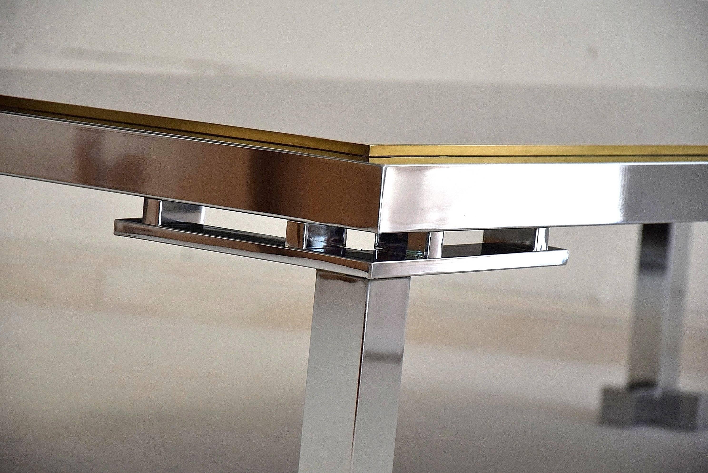 Chrome and brass hollywood regency coffee table.
Rare chrome and brass coffee table with smoked mirror top produced by Belgo Chrome, Belgium in the 1970s.
A truly stylish and cool coffee table.
Measurements : W 62 x D 132 x H 35 cm.
Table will be