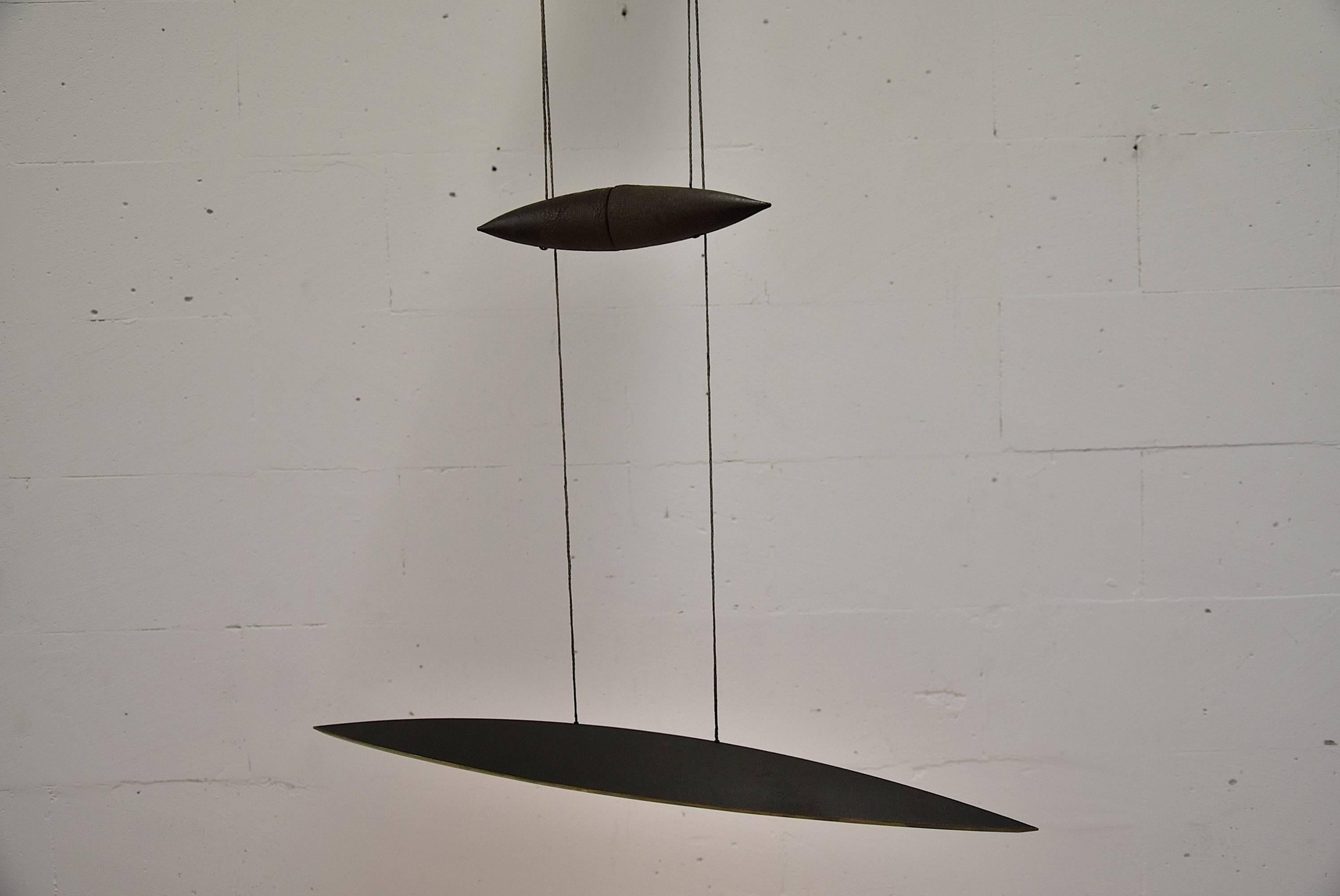 Solid Raw Bronze Tai Lang 1990s pendant fixture by Tobias Grau out of production.

The shape, material and light make Tai Lang a very special pendant fixture. 
The shade of high-grade metals is balanced by a counterweight of the same material,