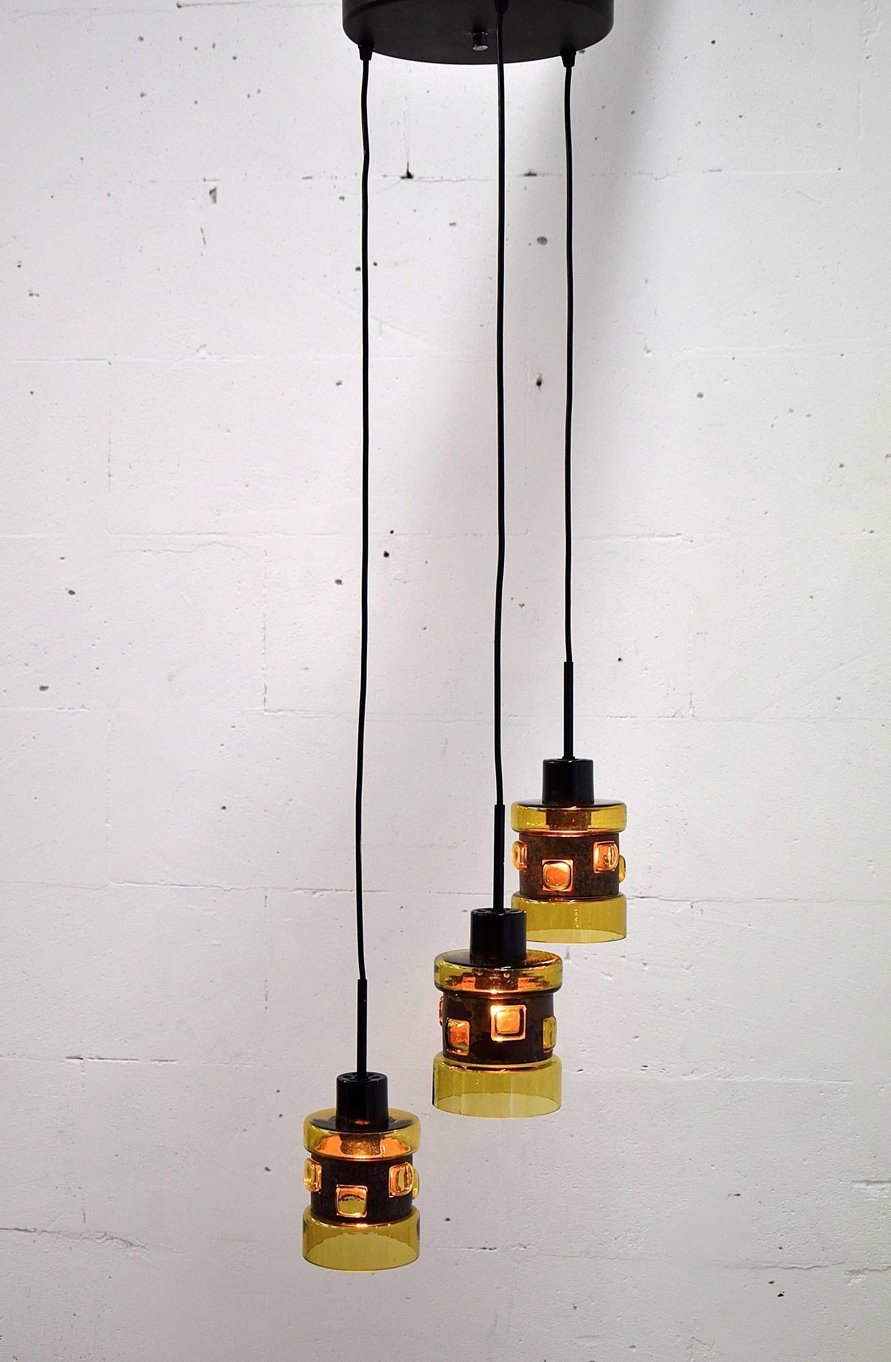 Mid-Century ceiling pendants by Nanny Still McKinney.
Stunning early 1960s amber colored handblown glass with patinated copper perforated rings produced by RAAK, the Netherlands.
Nanny still was influenced by the Arts and Crafts movement which shows