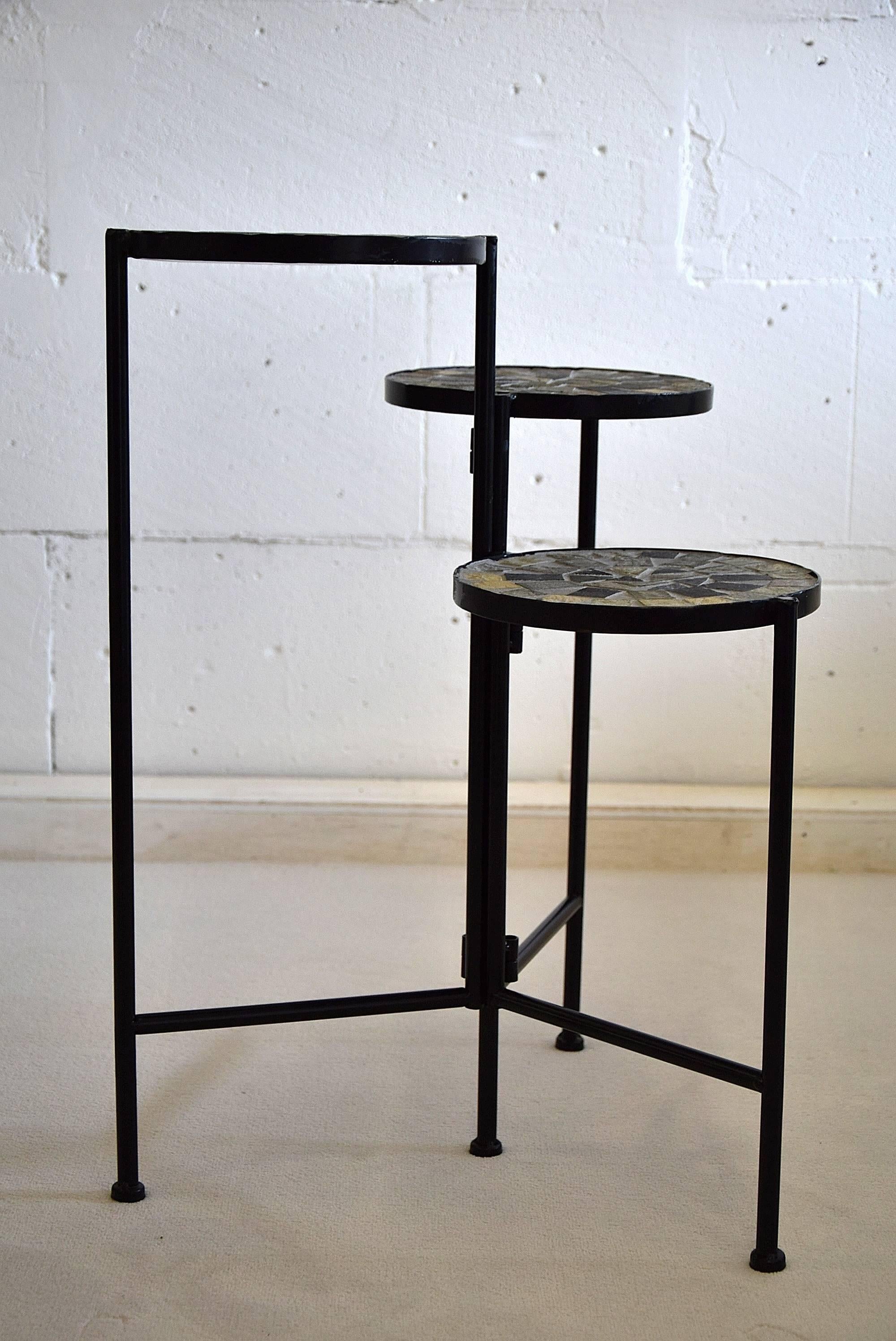 Dutch Mid-Century Modern plant stand
Very stylish and typical 1960's metal and mosaic plant stand in great condition.

Each of the three tiers has a diameter of 22 cm heights od 60, 51 and 41 cm.

Plant stand will be shipped abroad in a custom-made