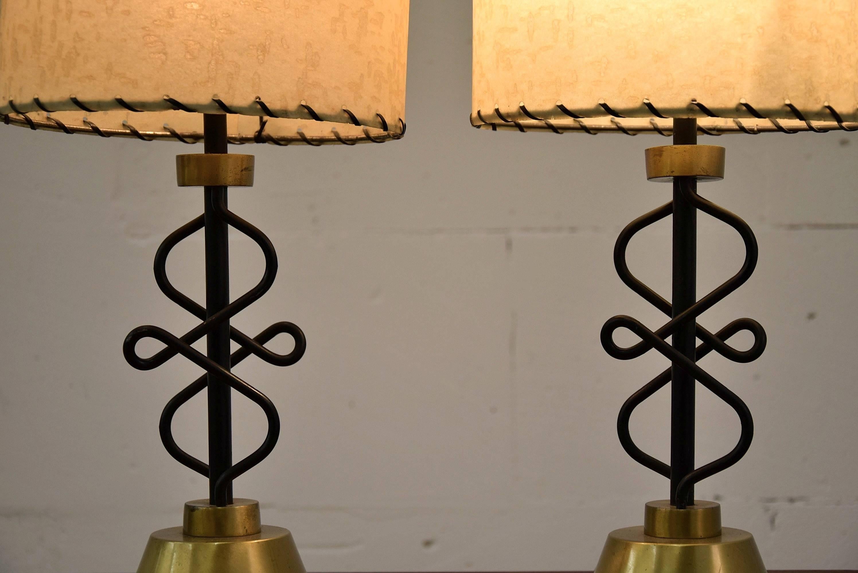 Unusual and rare Mid-Century Majestic table lamps.

Wonderful shaped body, brass feet and original parchment shades.