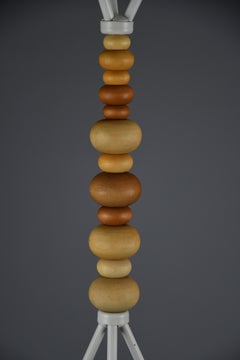 Sculptural white lacquered steel coat stand with turned wooden beads