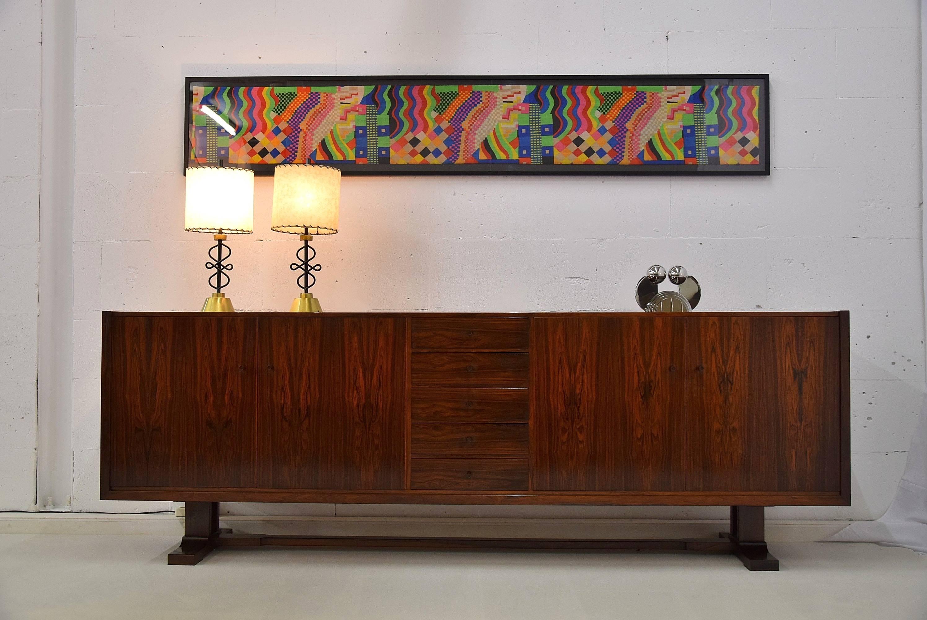 Mid-Century sideboard.

Sophisticated and stunning sideboard made by outstanding craftsmen, the Gebroeders (brothers) Van Straten in Rotterdam, the Netherlands in the 1950s. 

The credenza is standing on a solid rosewood pedestal and the rosewood