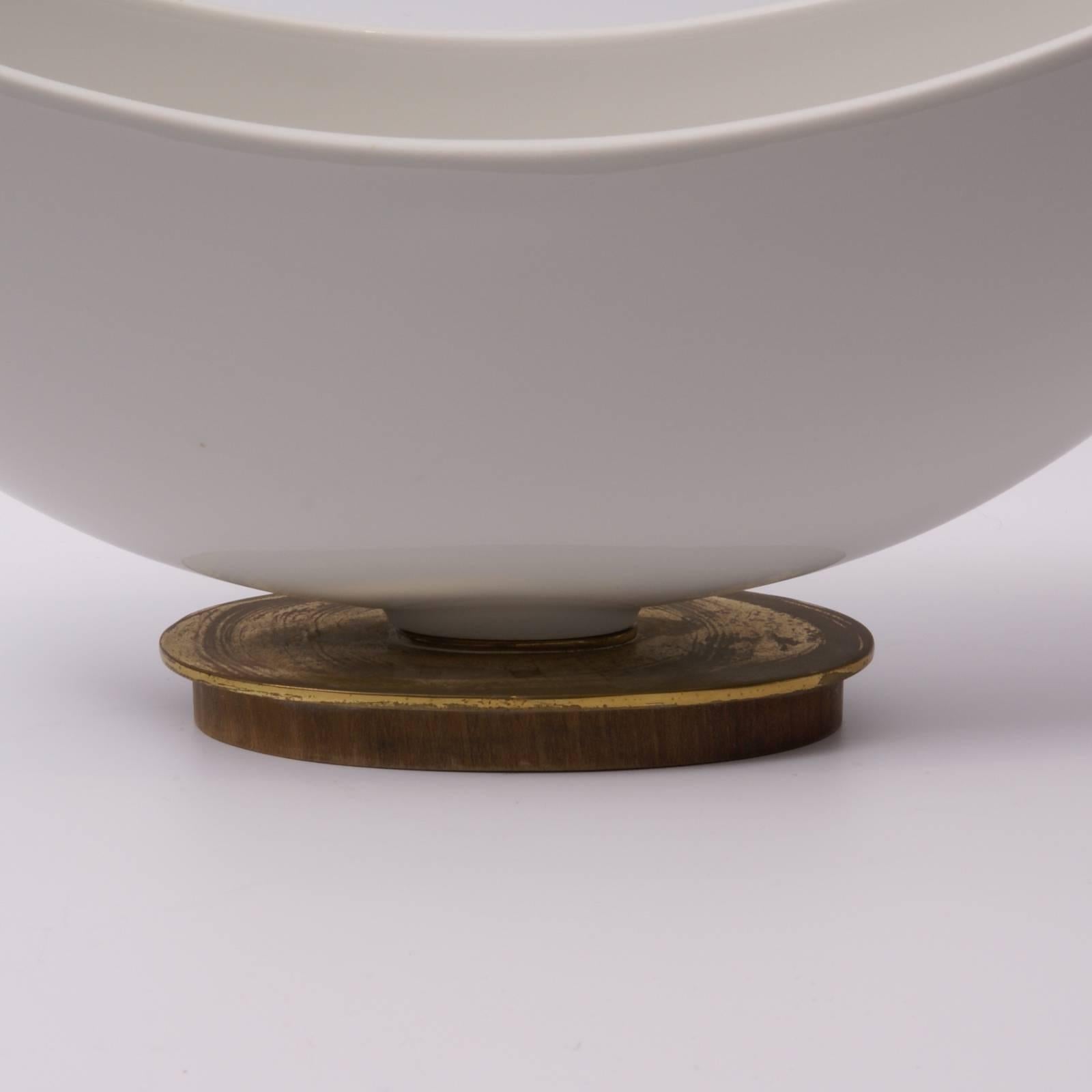Stylised porcelain flower holder with his original porcelain divider (both parts signed ) on wood and brass oval foot, designed by Siegmund Schütz for K.P.M.(Königliche Porzellan Manufaktur).
Lit: 