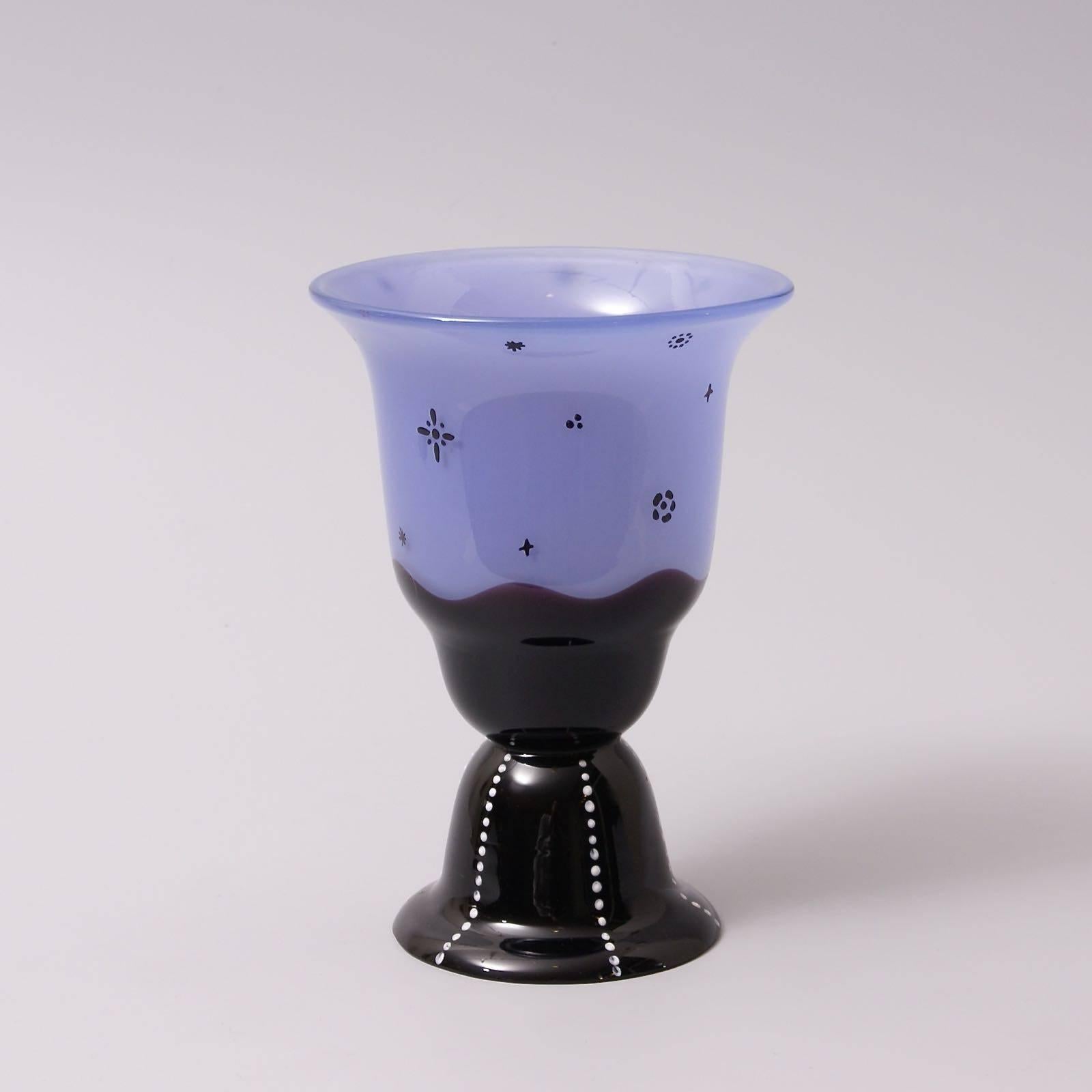 The blue glass footed vase partially covered with a black layer at the base, black enamelled decoration on the vase, white enameled dots on the foot (some white dots erased, visible om the image 3) produced by Loetz after a Dagobert Peche design.