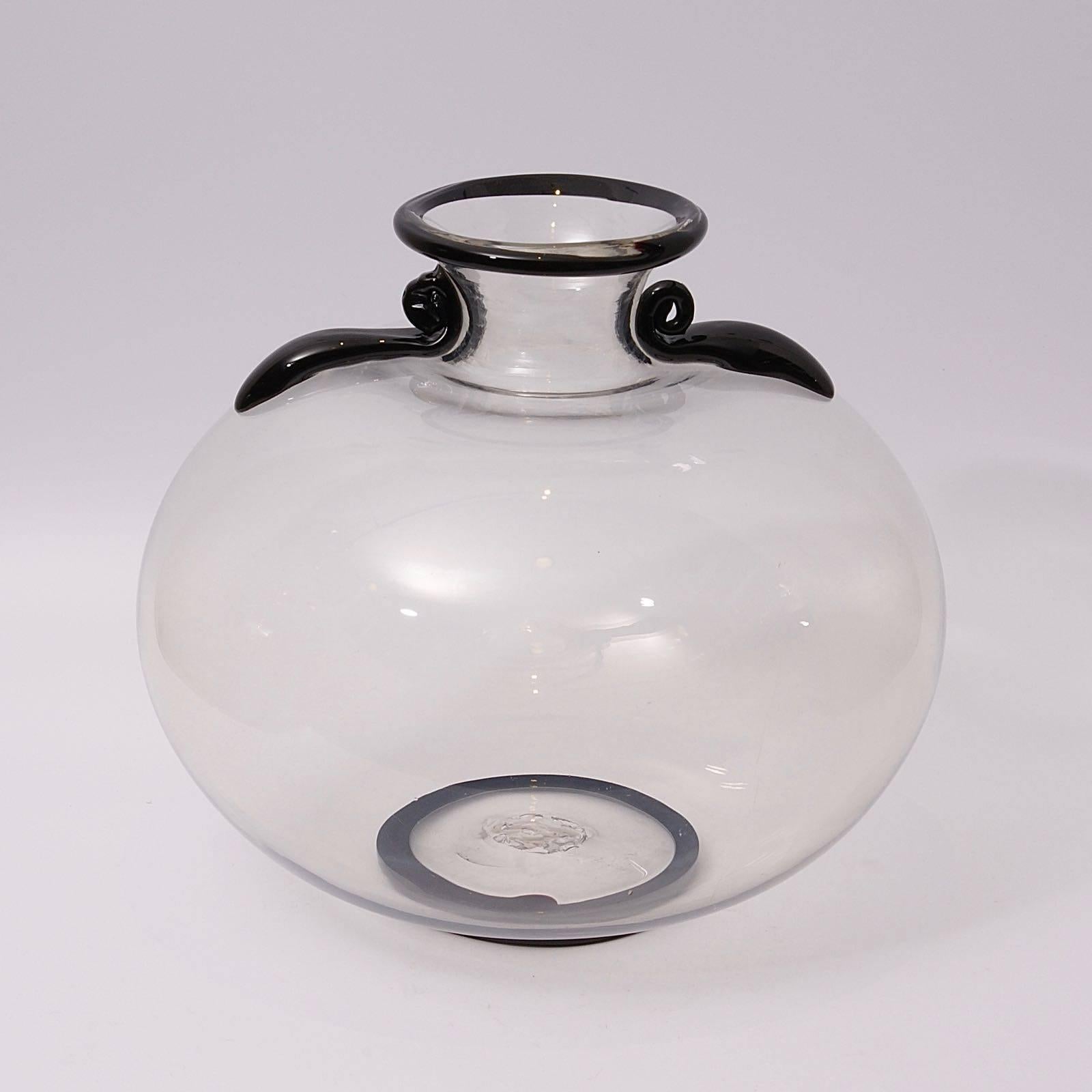 Large clear glass vase with two scrolls at the base of the neck, design by Napoleone Martinuzzi for Venini, circa 1927. Similar piece illustrated in: 