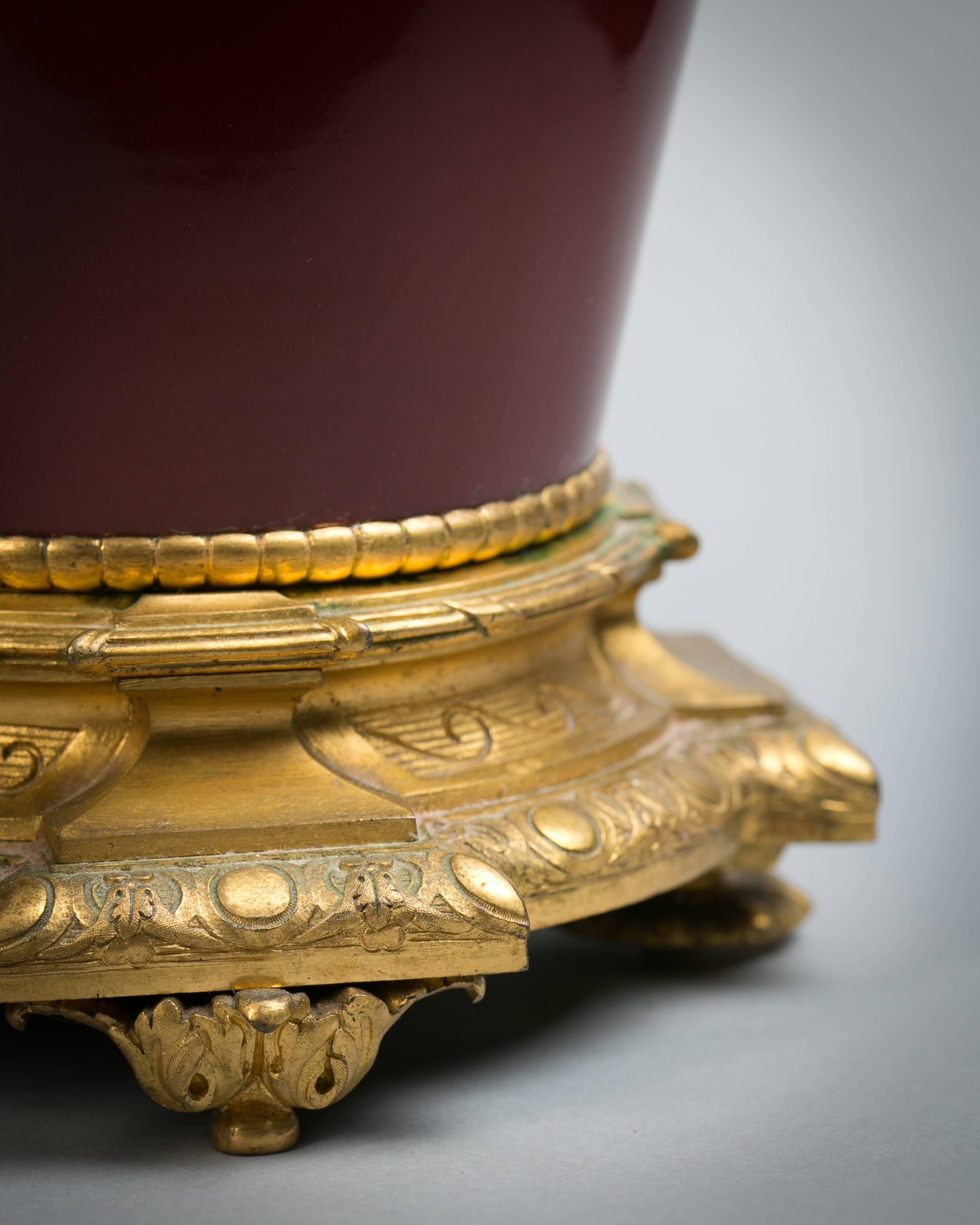 Pair of gilt bronze vases with leaf-cast handles forming into female masks.