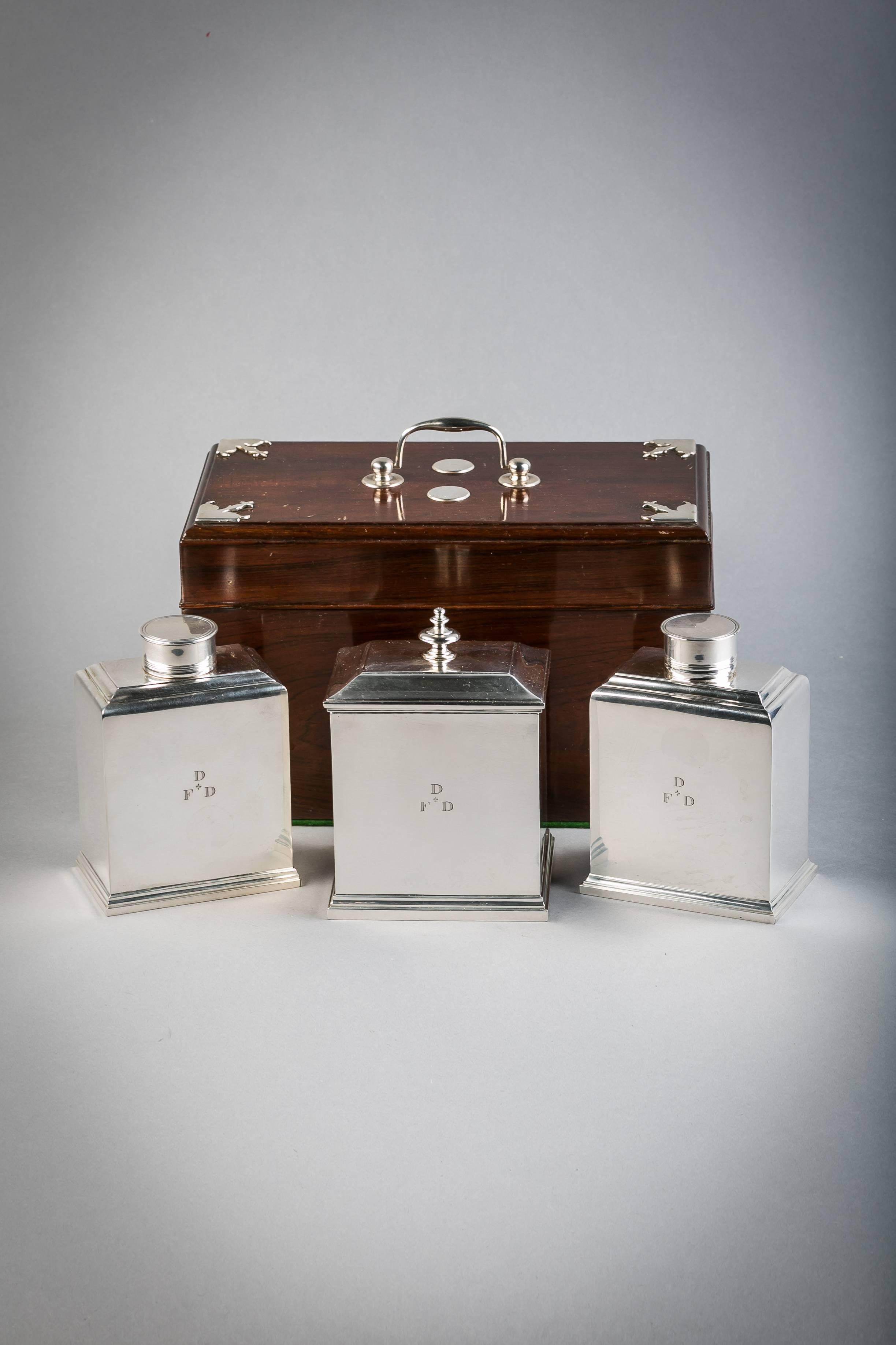 Consisting of a pair of tea caddies and a sugar box in its original wood container. 