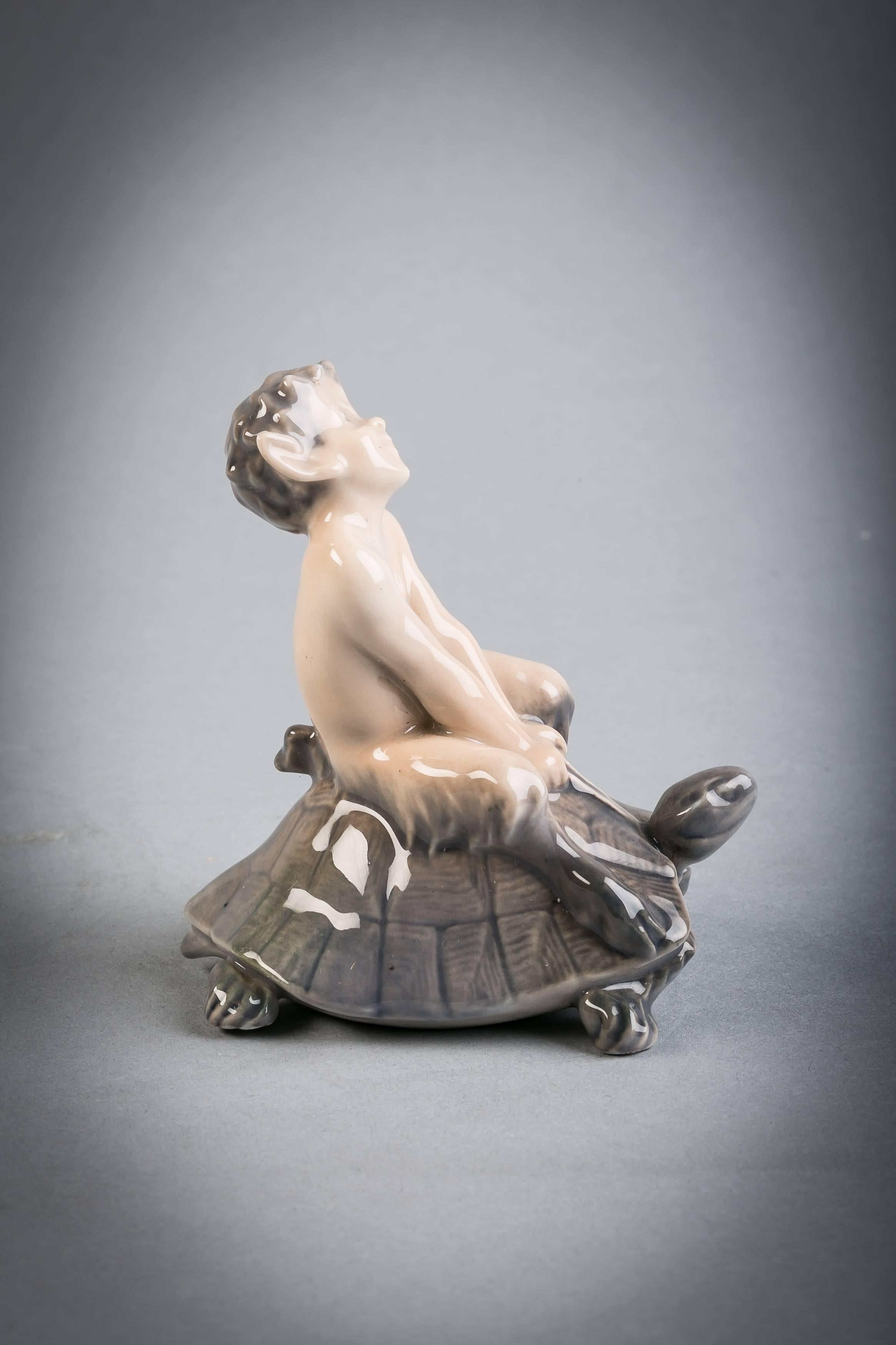 Royal Copenhagen porcelain faun on tortoise.

Dated 1969-1974.