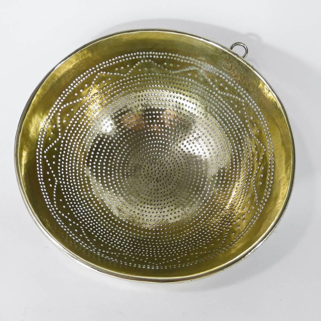 Swedish brass colander, circa 1820. Hand rolled rivet holding hanging ring. Remarkable condition. Measures: Depth: 5″, diameter: 11 1/4″.