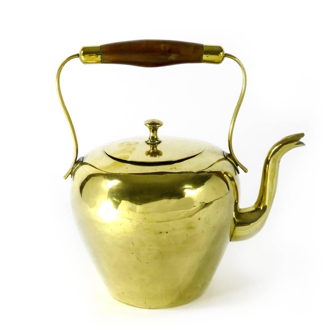 Dutch brass kettle, circa 1800. Wood handle. Dovetailed. Small repair to top of spout. Measures: Height 9″, DOB 3 3/4.